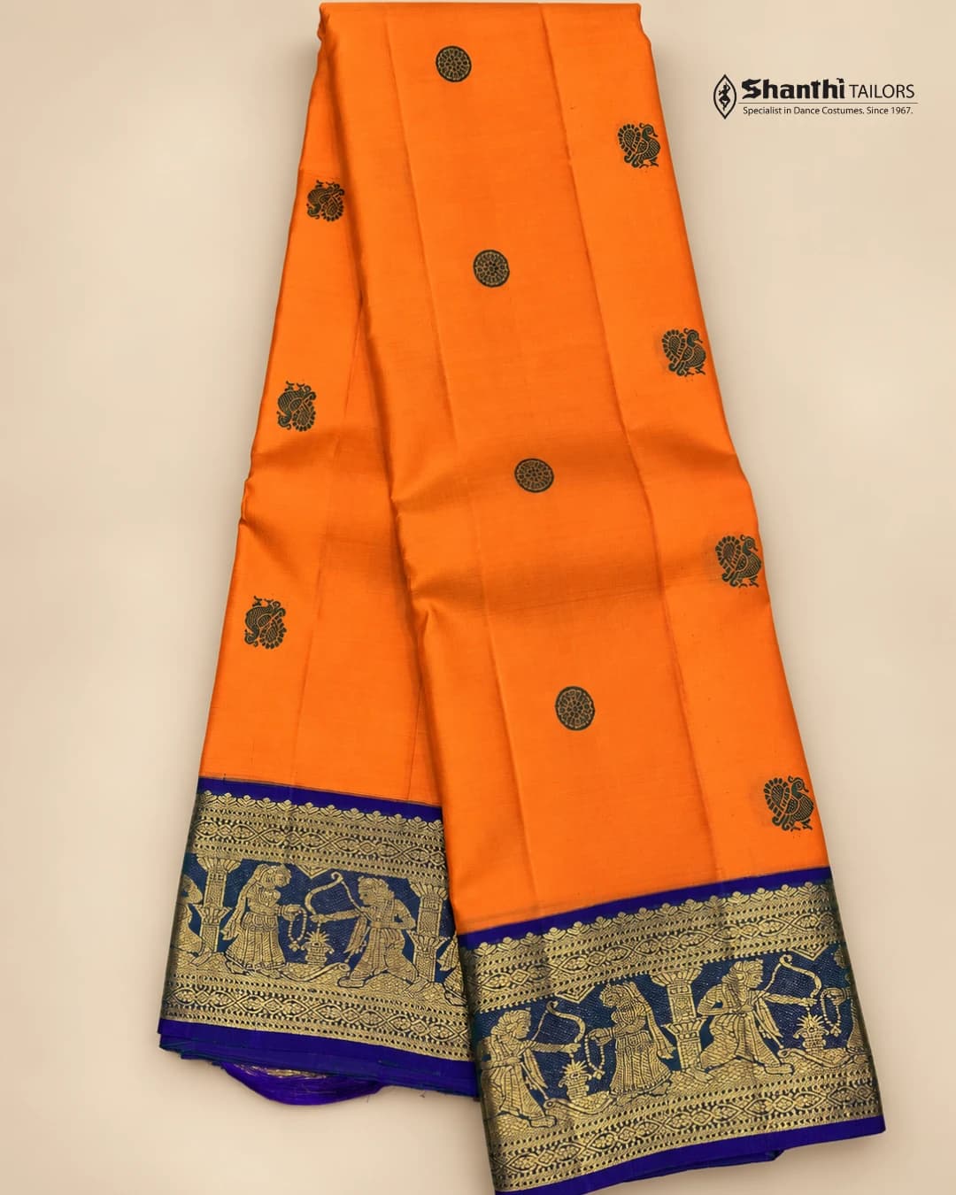 Pure Kanchipuram Silk Saree: Orange body, royal blue border with golden mythological figures & peacock motifs.