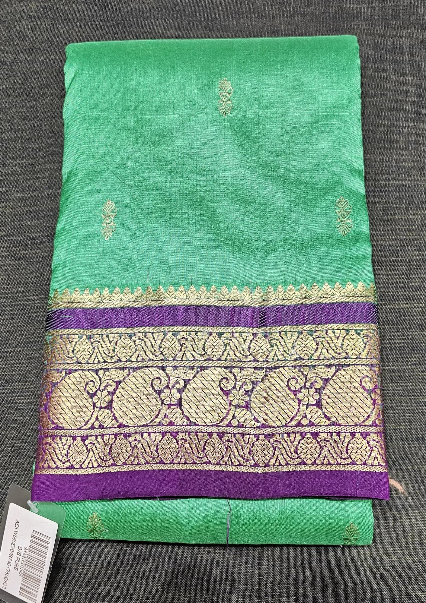 Green Dharmavaram Silk Saree with Vadamalli border, adorned with intricate gold zari work.