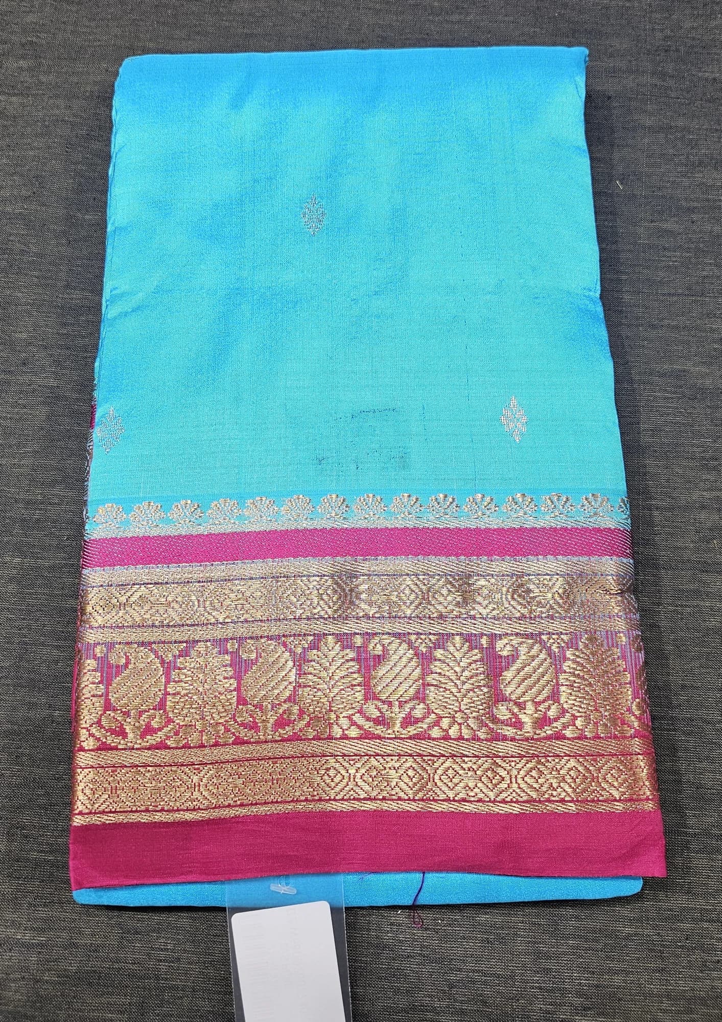 Sky Blue Dharmavaram Silk Saree with a broad magenta and gold zari border.