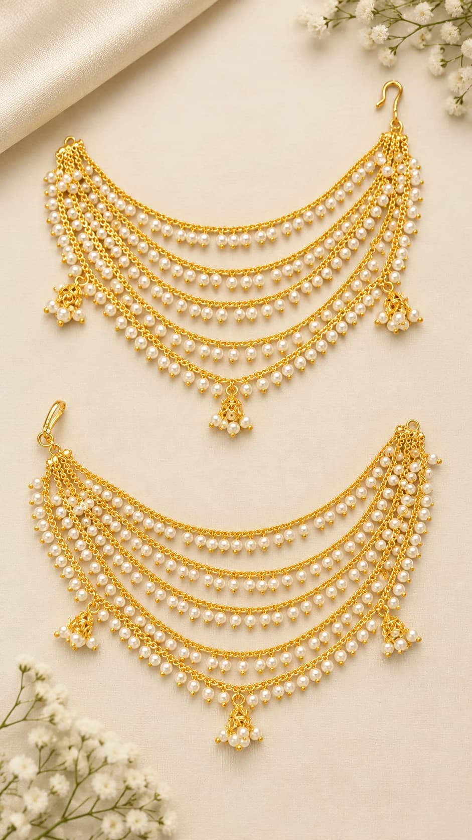 Antique Mattal fashion jewellery: two golden ear chains with multiple pearl-studded layers and bell drops.
