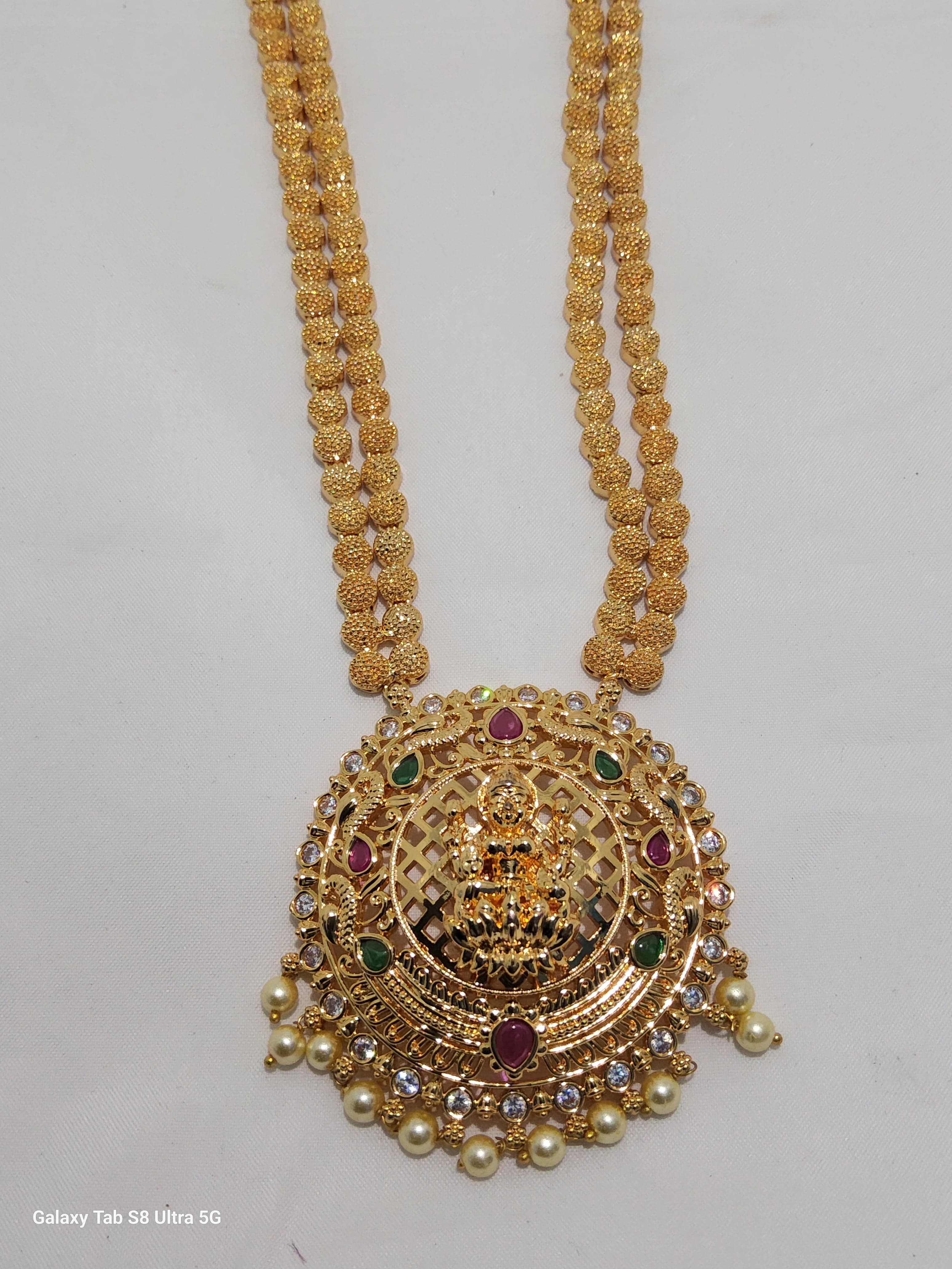 Lakshmi dollar chain, imitation jewellery. Elegant gold tone necklace with pearl accents.