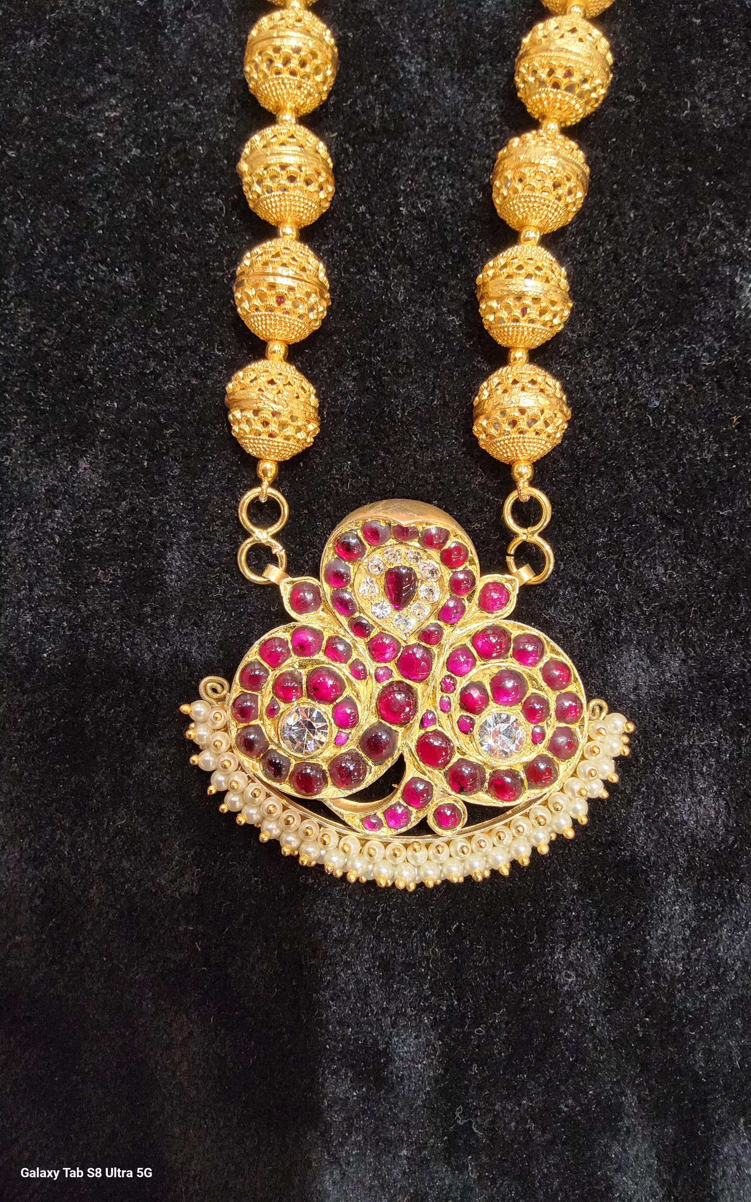 Ornate Balls Malai original temple jewelry, detailed close-up of traditional gold craftsmanship