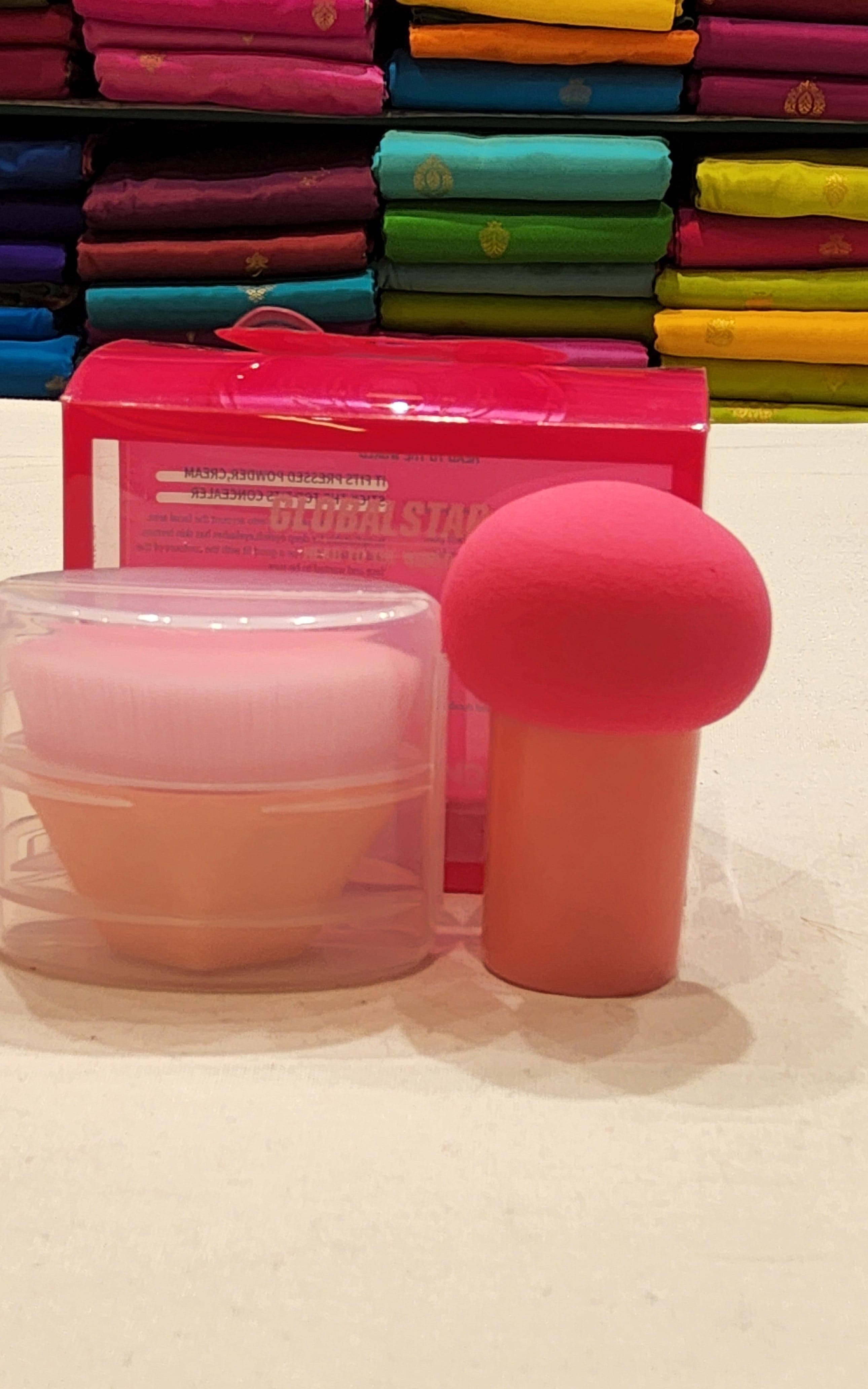 Makeup blender sponge held between two fingers, highlighting its precise application design.