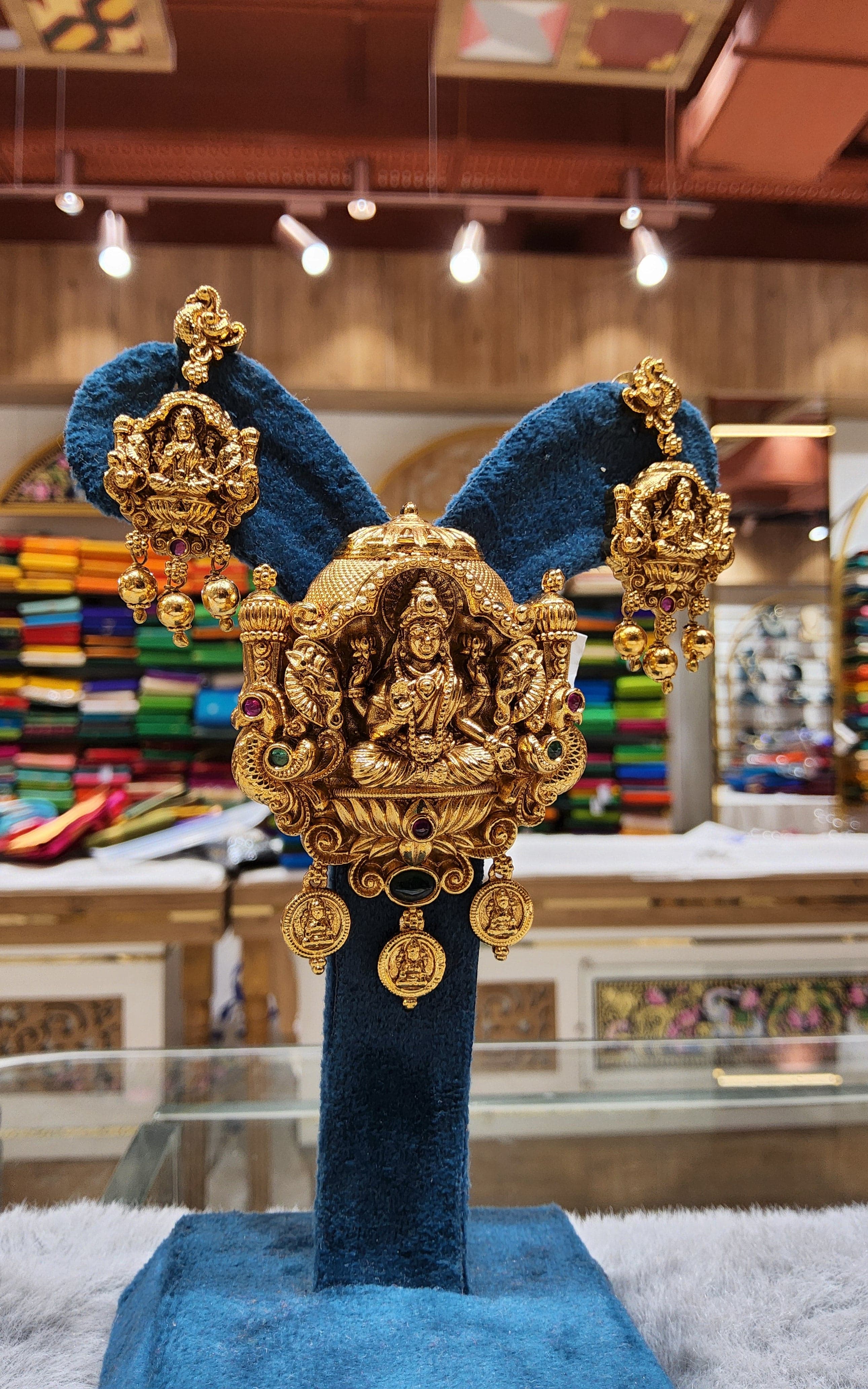 Matching earrings detail: Gold pendant set, traditional Indian jewelry for saree