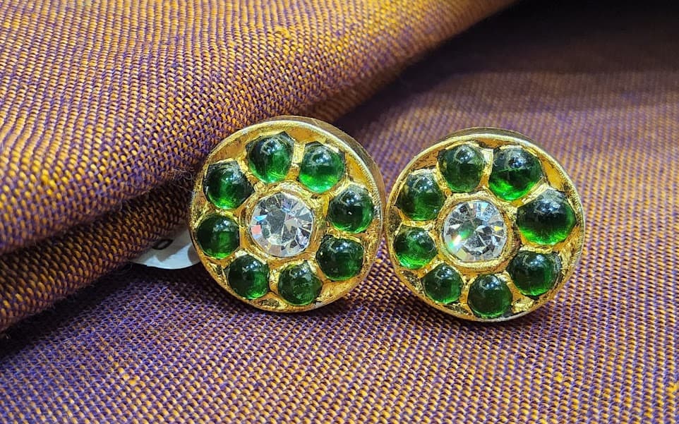 Round Temple Stud jewellery. Antique gold earring with red and green kemp stones detail.