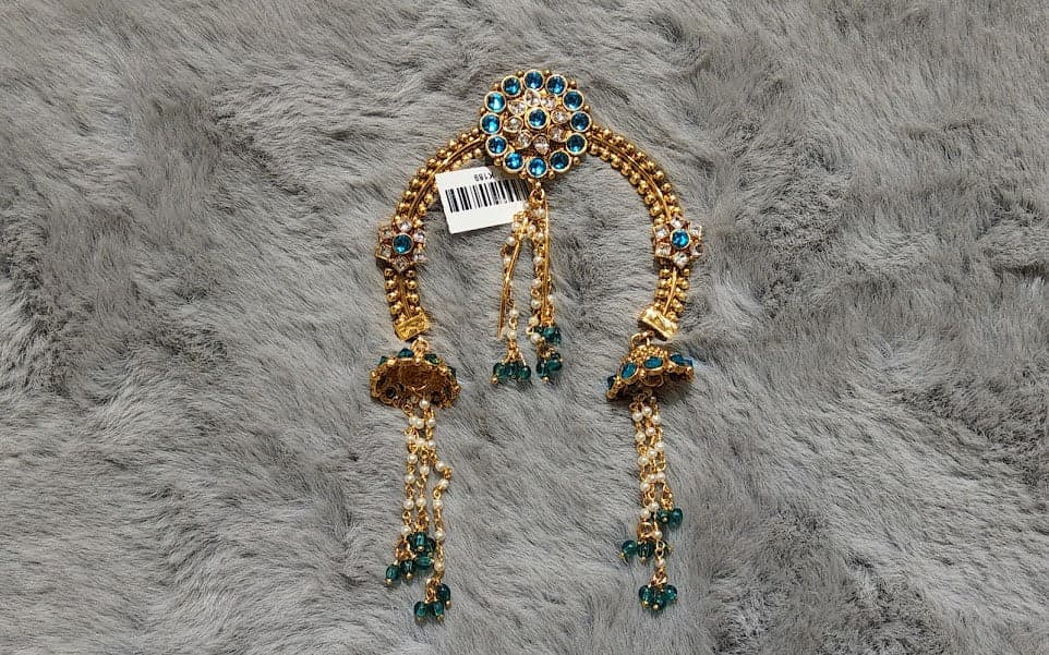 Antique Floral Arch Jada Billai: Intricate details of jhumki drops and chain layers.