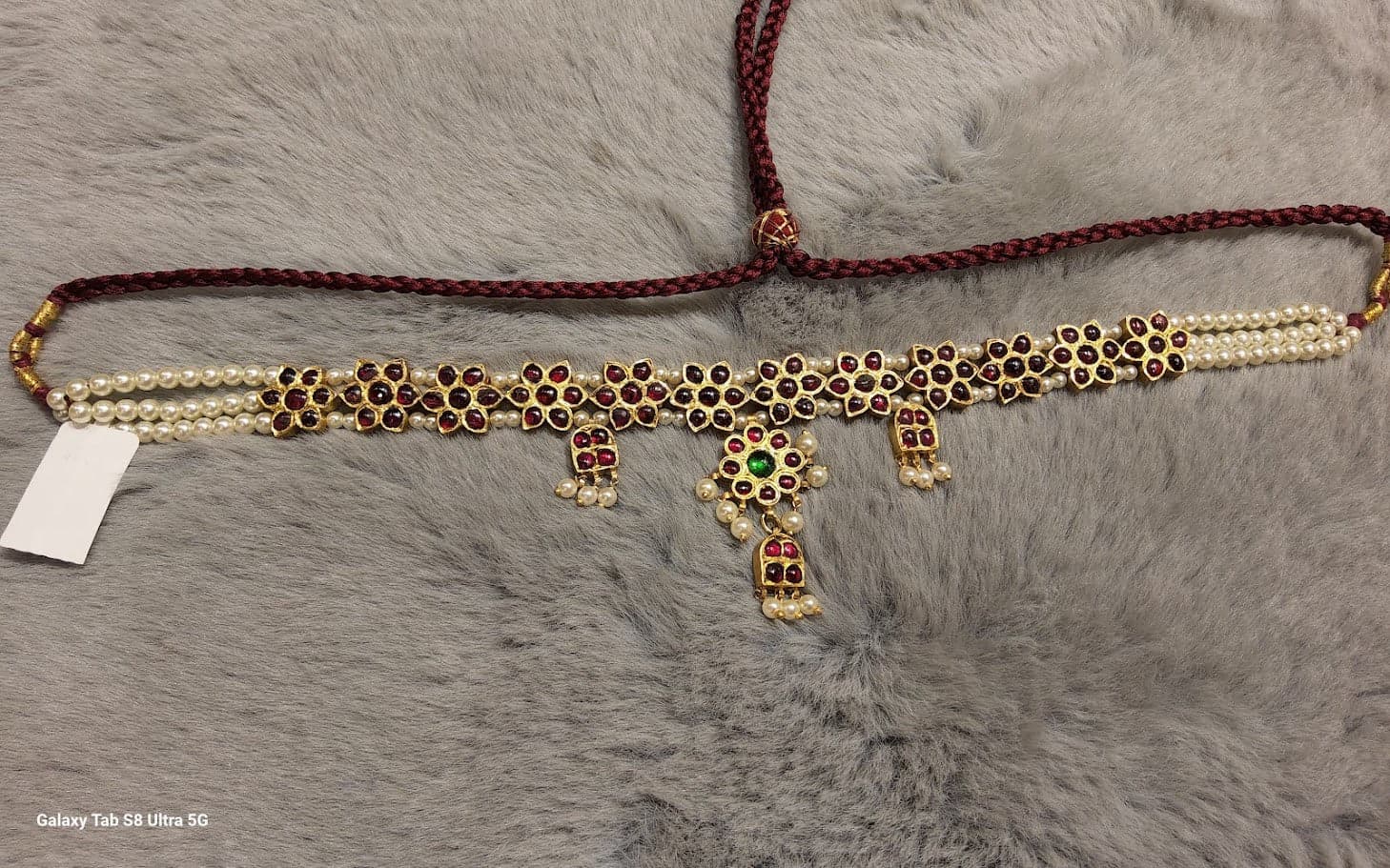 Flower Choker: Close up detail of temple jewellery floral motifs, traditional necklace design.