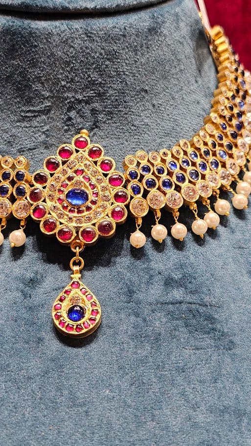 Close-up: 4 LINE DOT NECKLACE. Silver base gold leaf kemp stone temple jewellery necklace, bharatanatyam jewellery set.