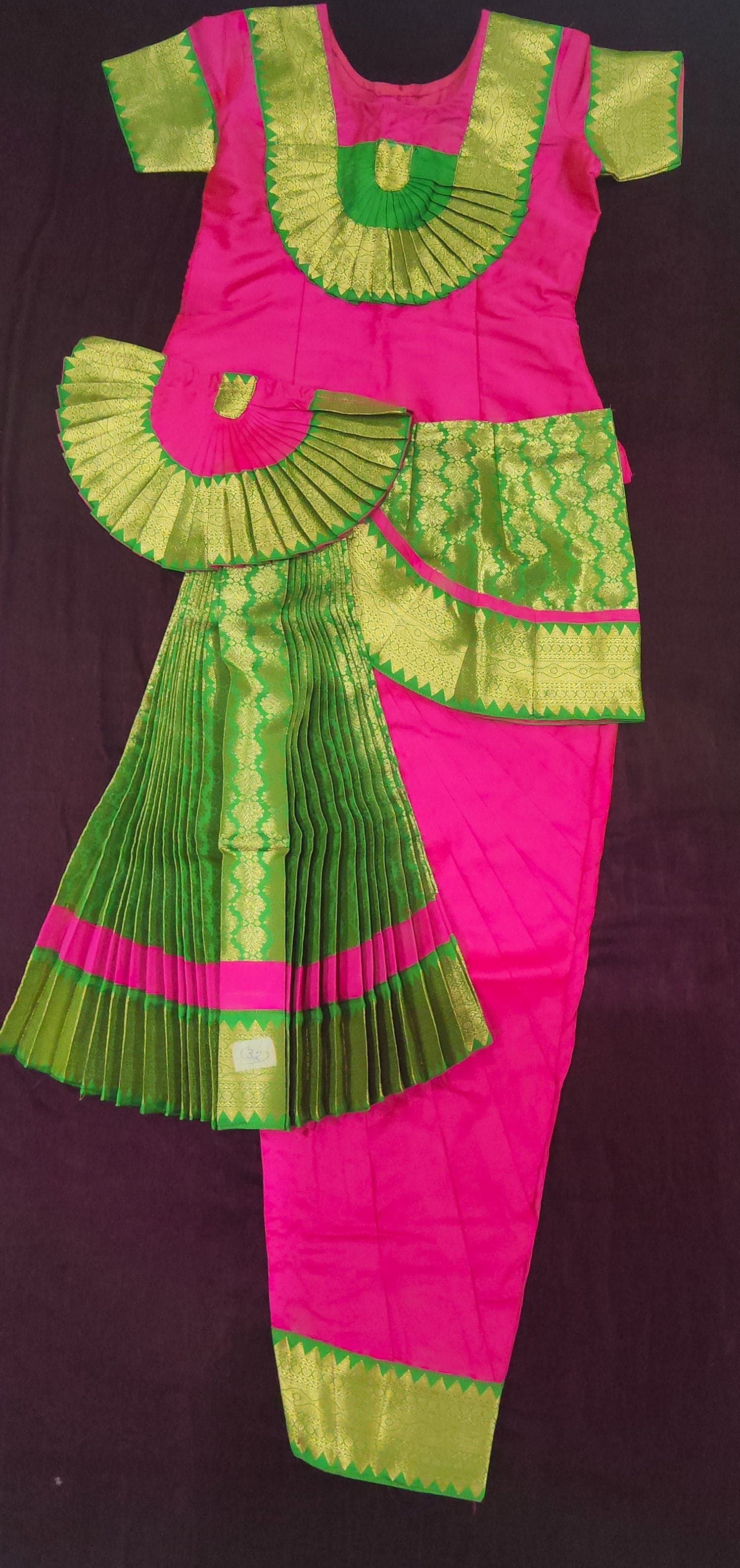 Close-up: Pink & Green silk cotton Bharatanatyam pant costume fabric texture and details.