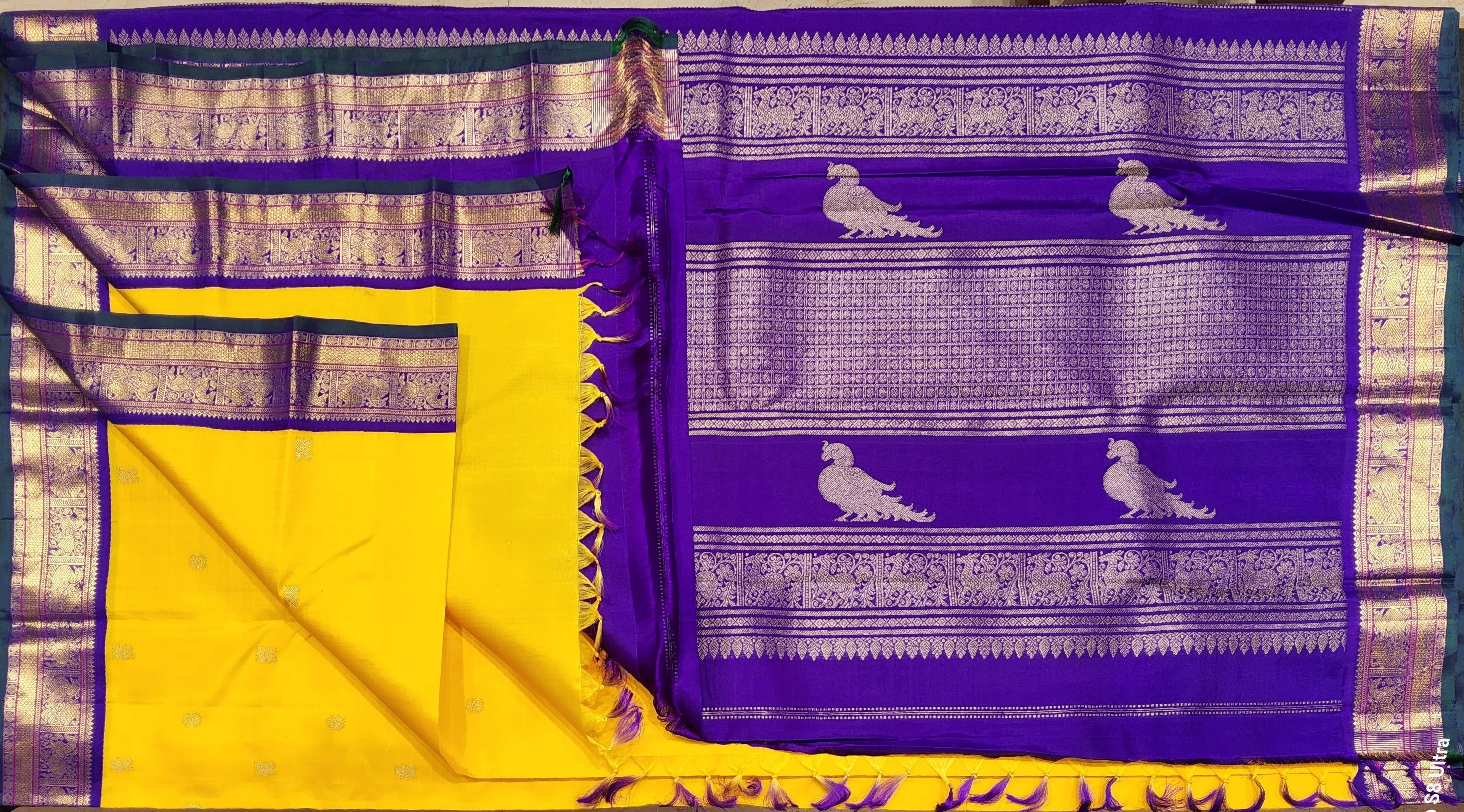 Draped Yellow Kanchipuram Silk Saree: Purple border elegance, South Indian style.