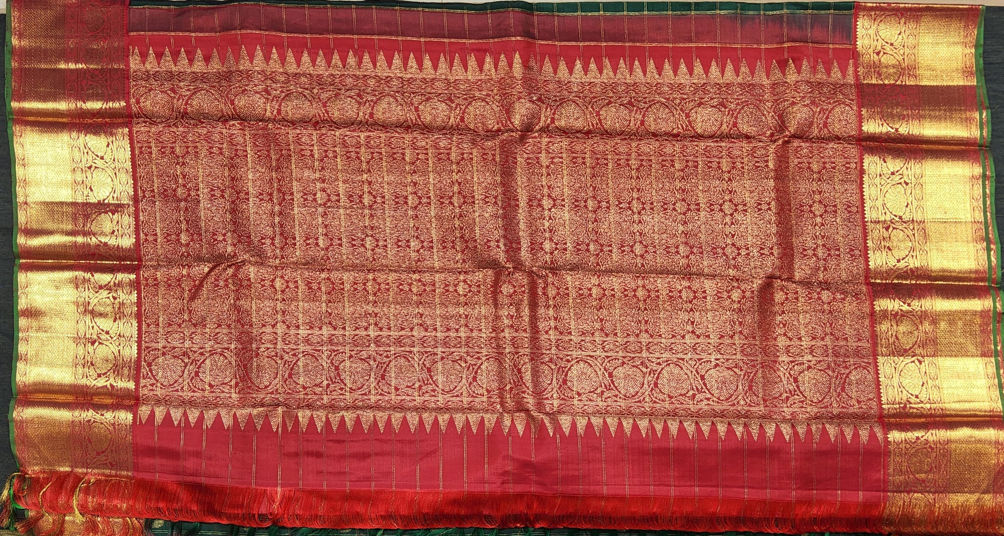Close-up of Green Kanchipuram Silk Saree KS9 red border and zari detailing. Pure silk weave.