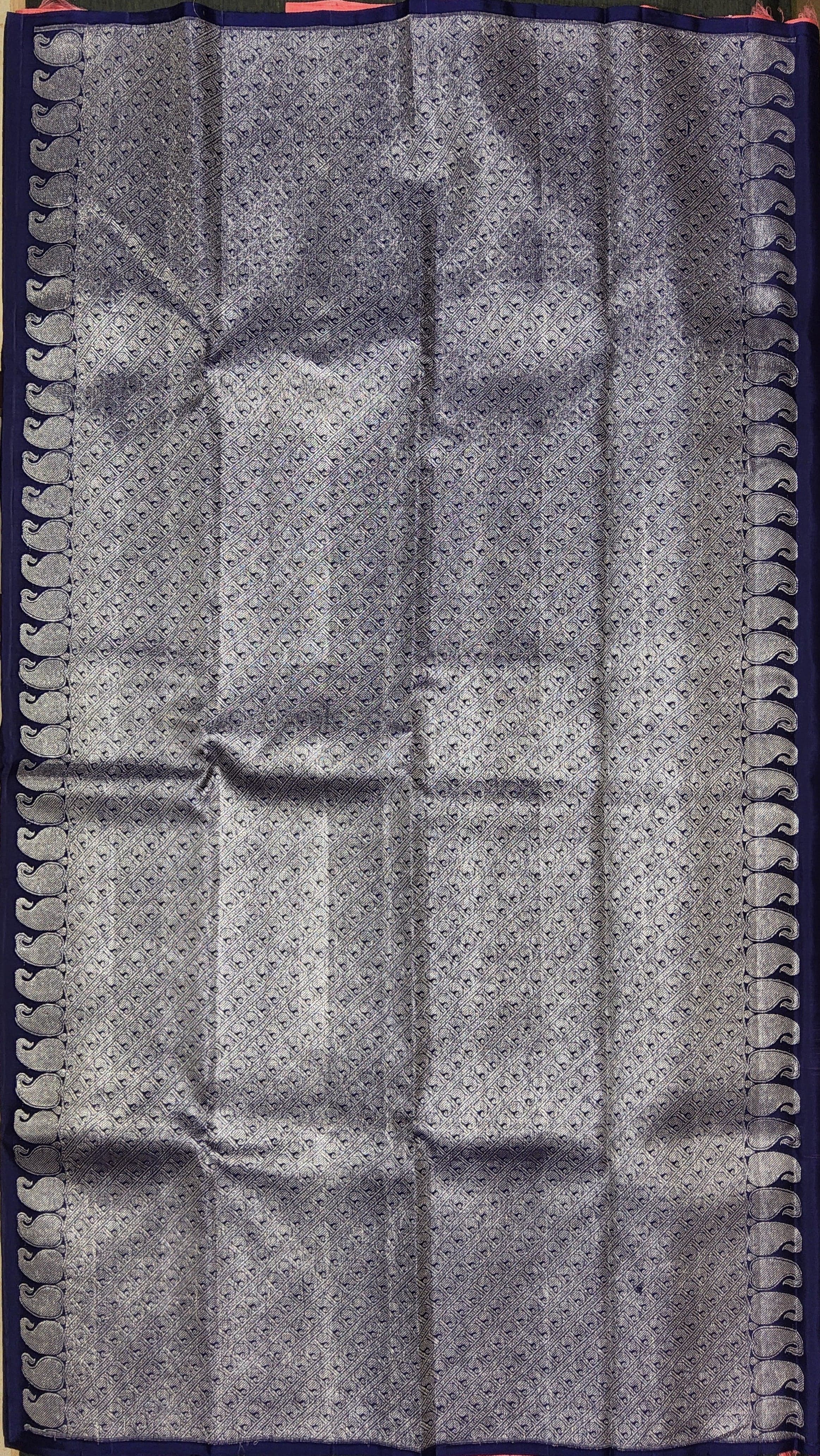 Close-up of Pink Kanchipuram Silk Saree zari work. Traditional handloom silk for Arangetram.