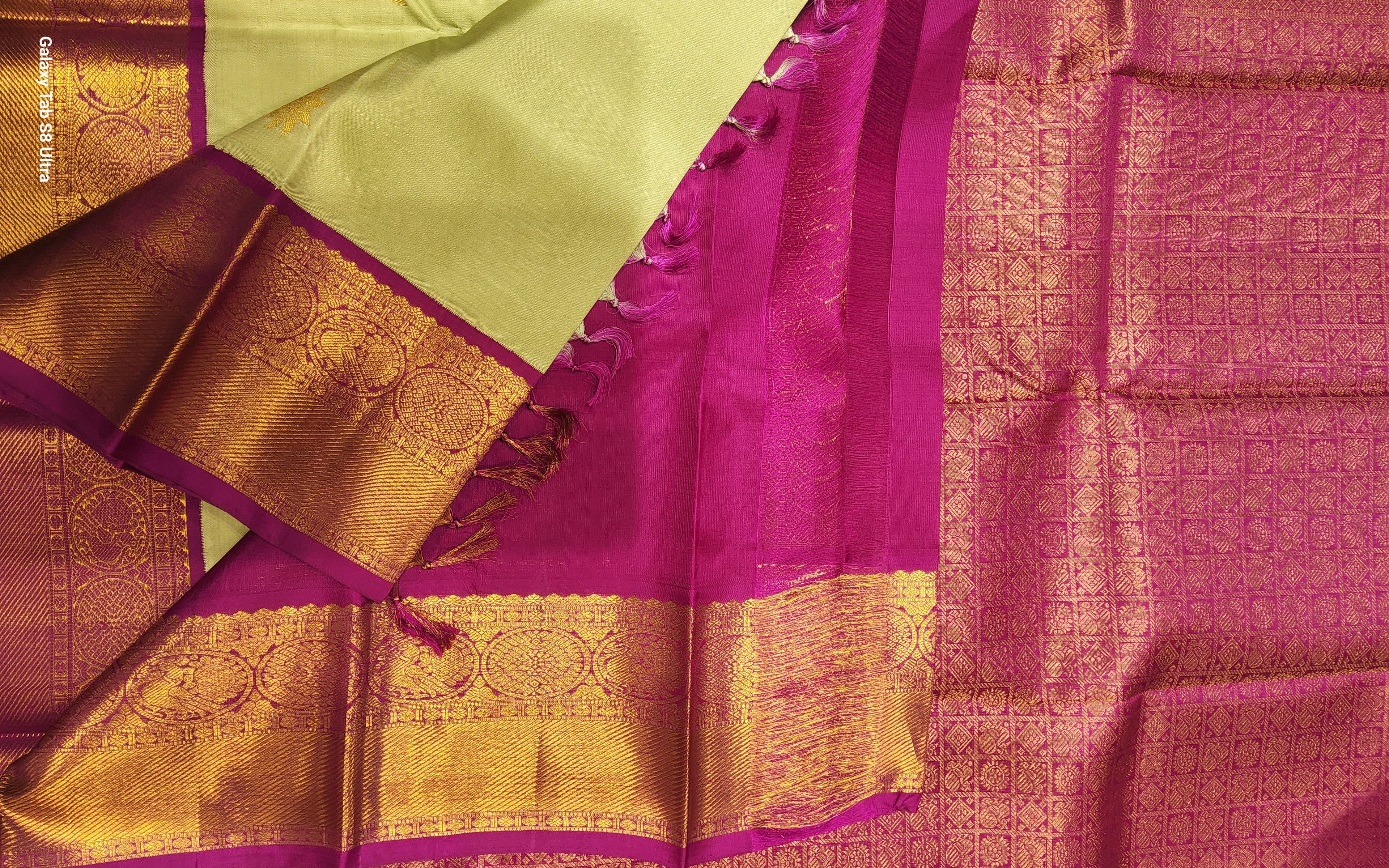 Light Green Kanchipuram Silk Saree HSN01 draped. Pink contrast border detail, wedding saree.