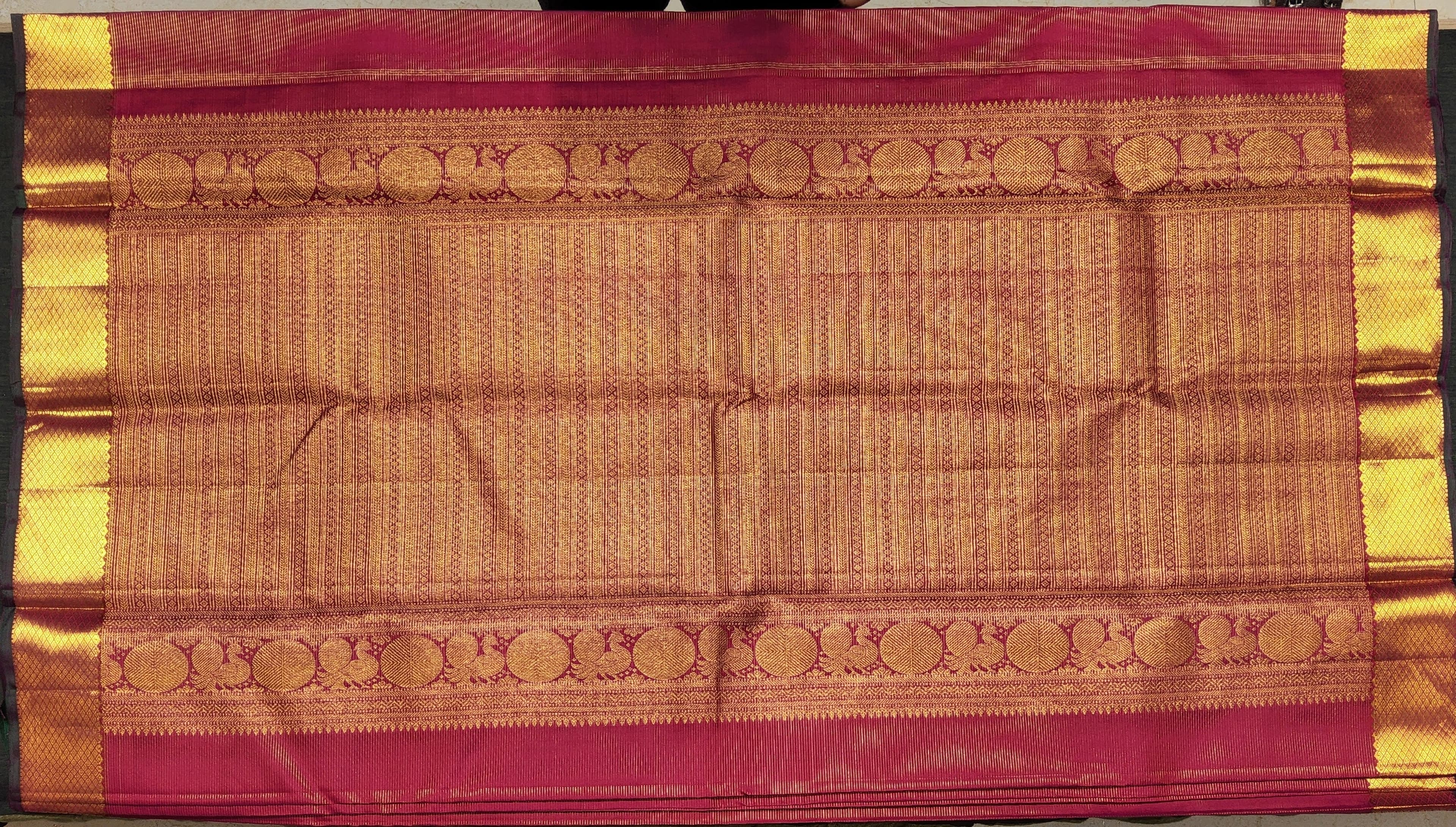 Elegant pink silk saree, Kanchipuram weave, zari work.