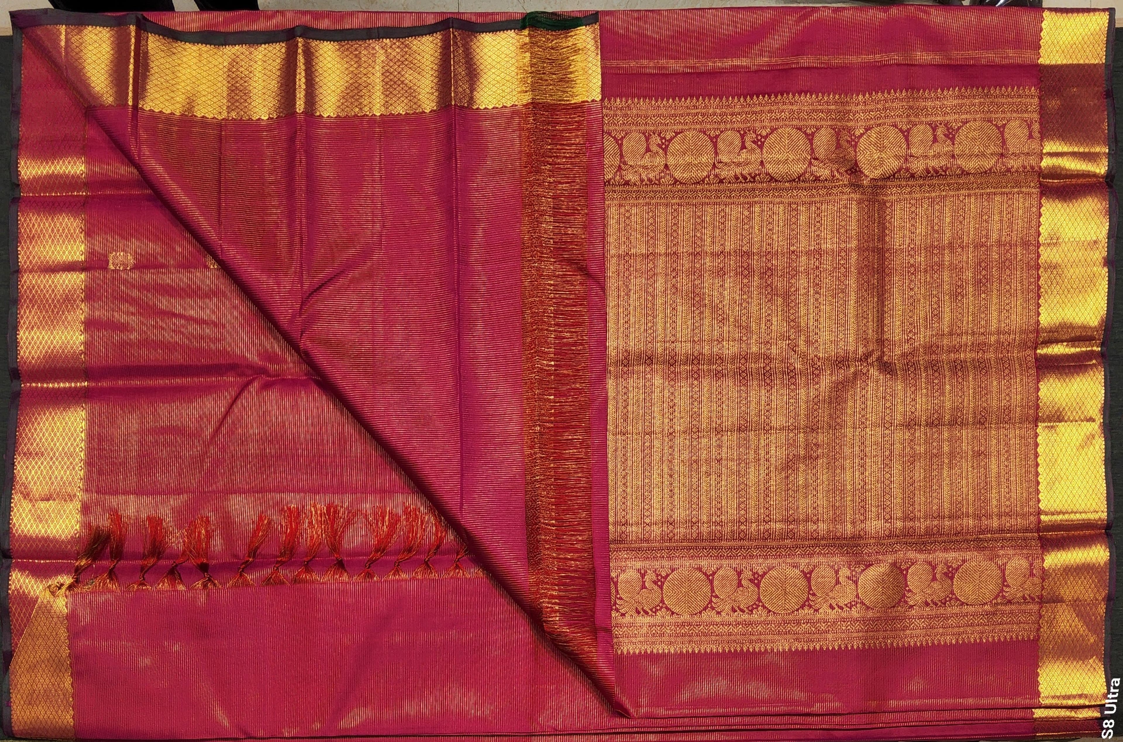 Premium pink silk saree fabric with gold border.