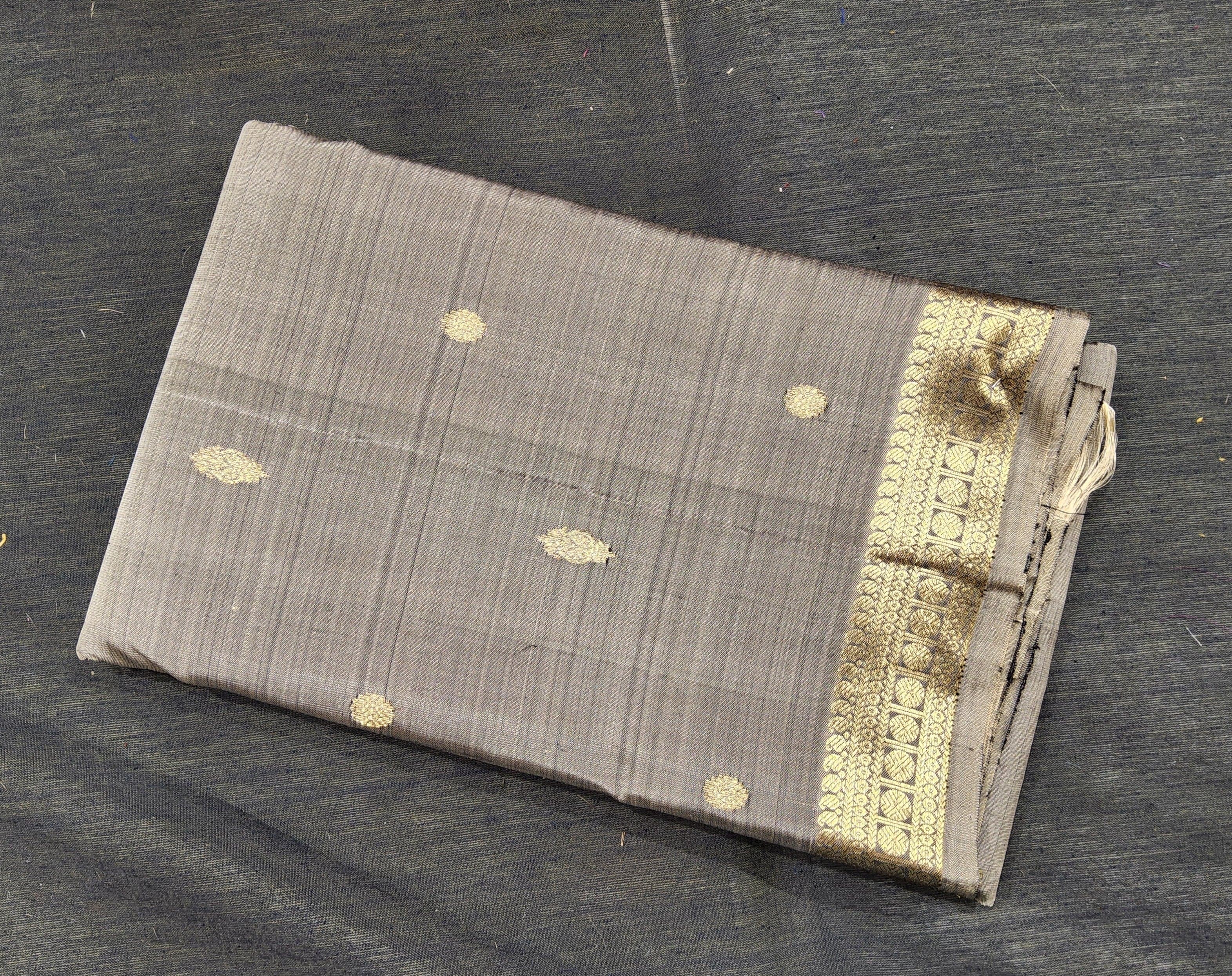 Grey Kanchipuram authentic silk saree for Arangetram; gold zari buttas and border detail.