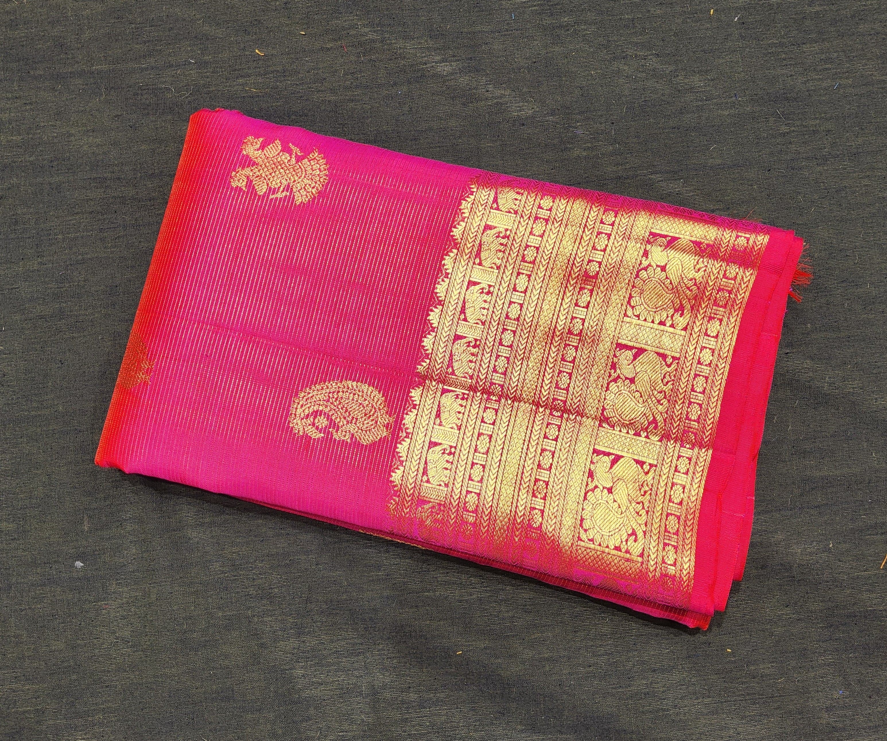 Rani pink authentic silk Kanchipuram saree, gold zari border detail. Perfect for Arangetram.