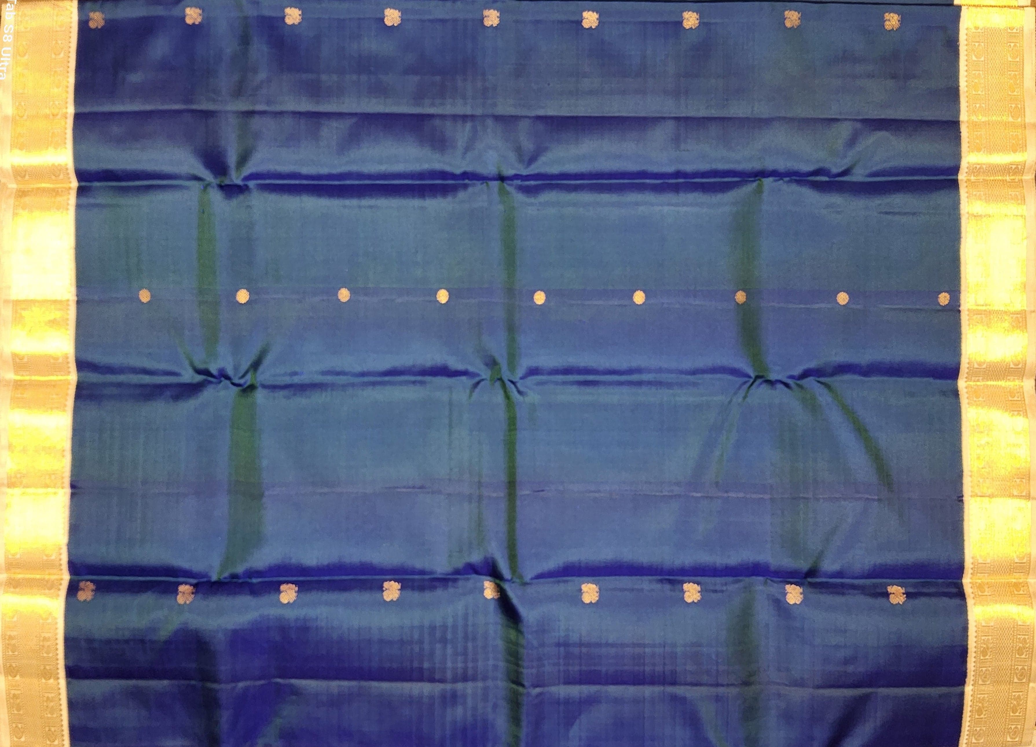 Close up of gold zari work on authentic silk Kanchipuram saree for dance.