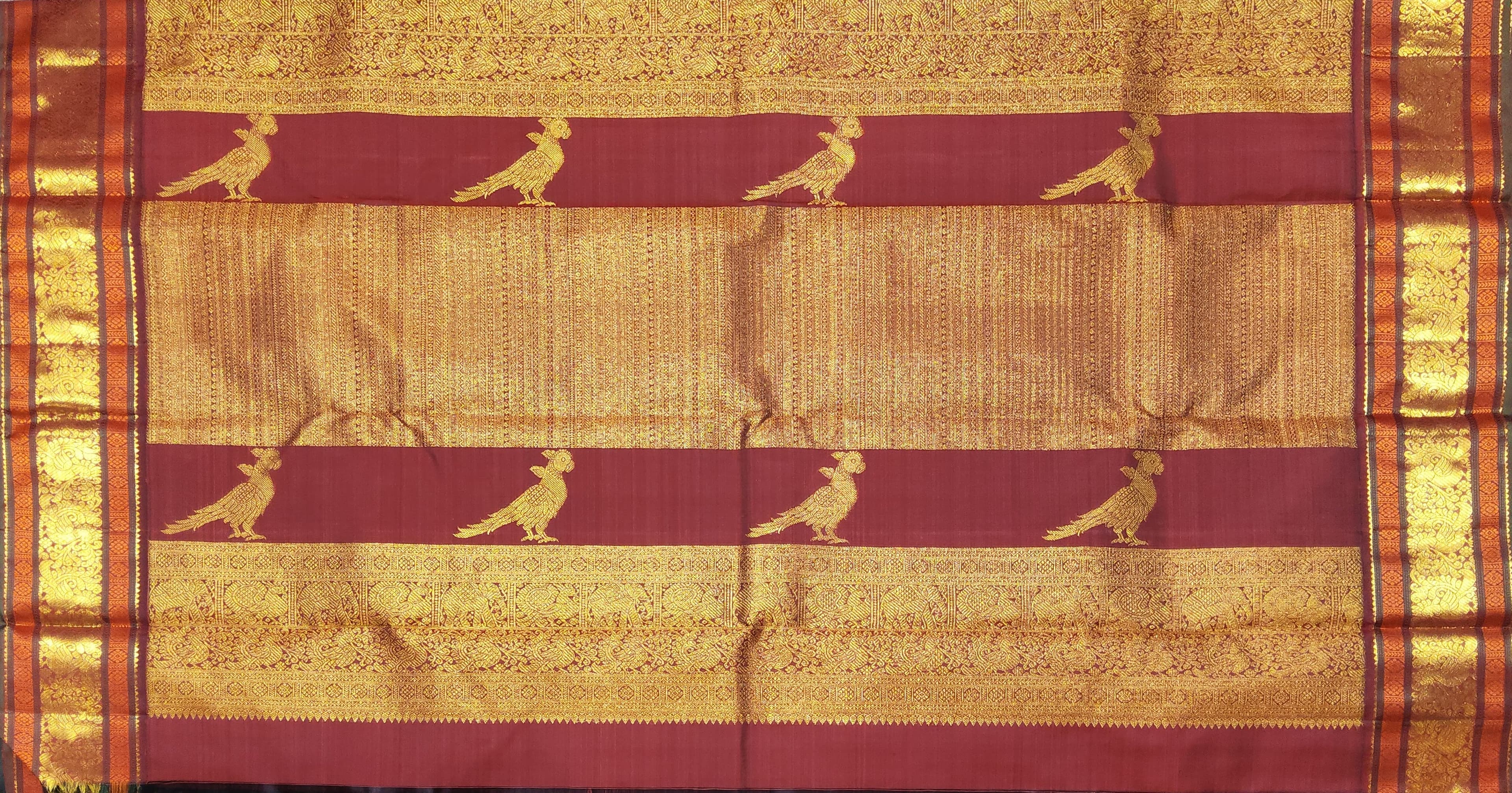 Kanchipuram authentic silk saree close-up, maroon & gold zari border detail. Perfect arangetram costume.