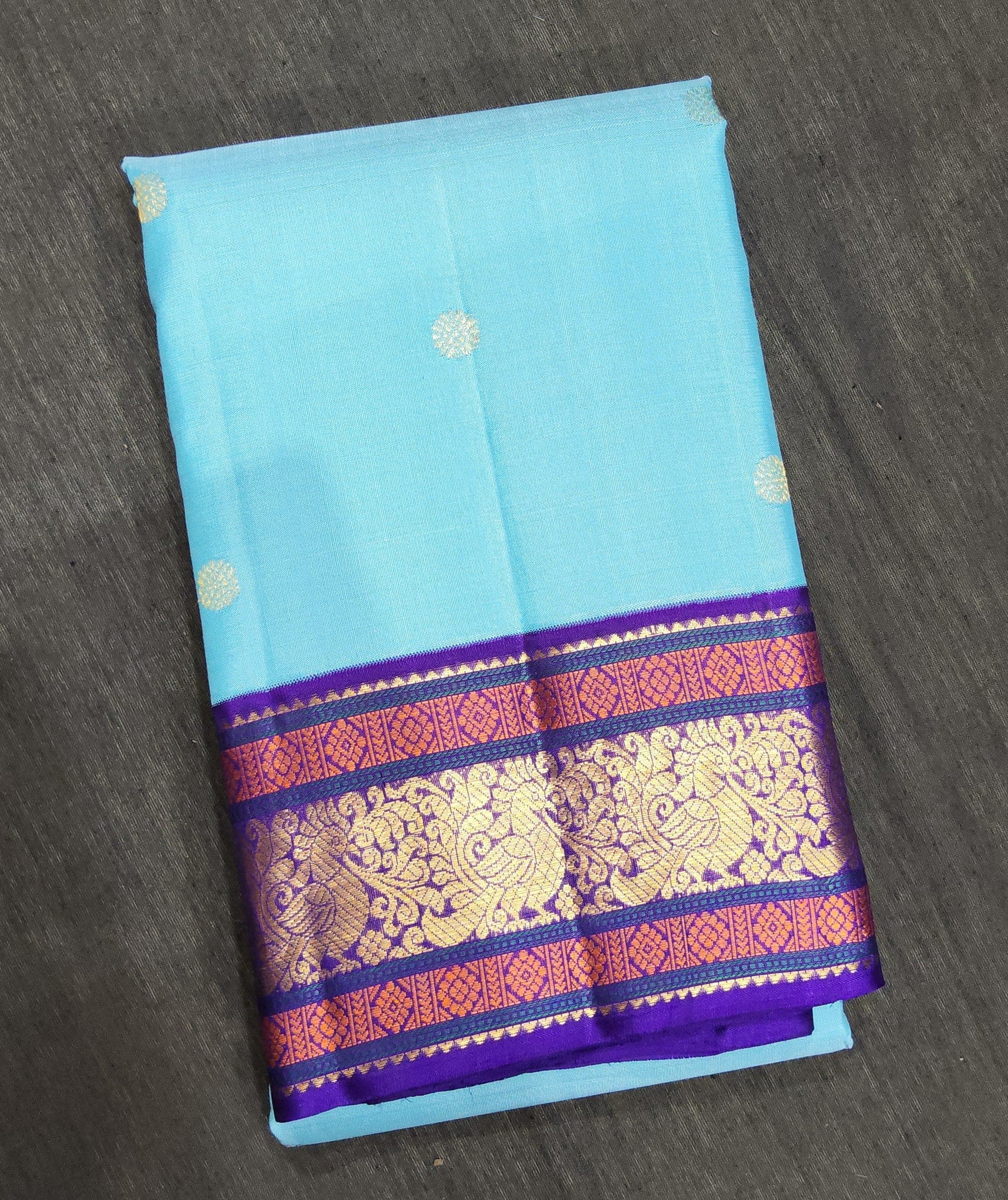 Light blue Kanchipuram authentic silk saree with purple border and gold zari, perfect for arangetram.
