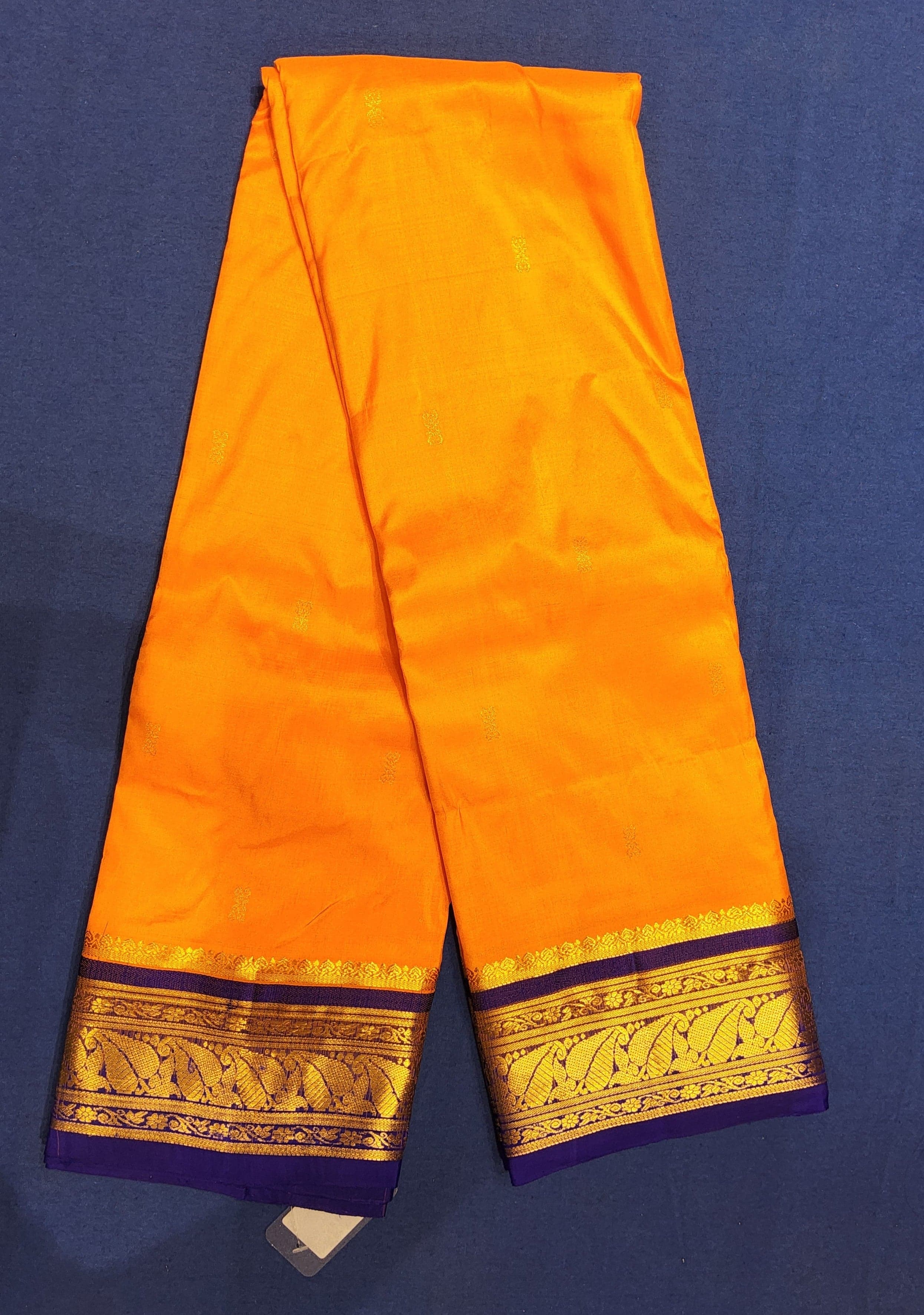 Close up of Dharmavaram silk saree pallu. Mango yellow with ink blue border. Authentic silk.