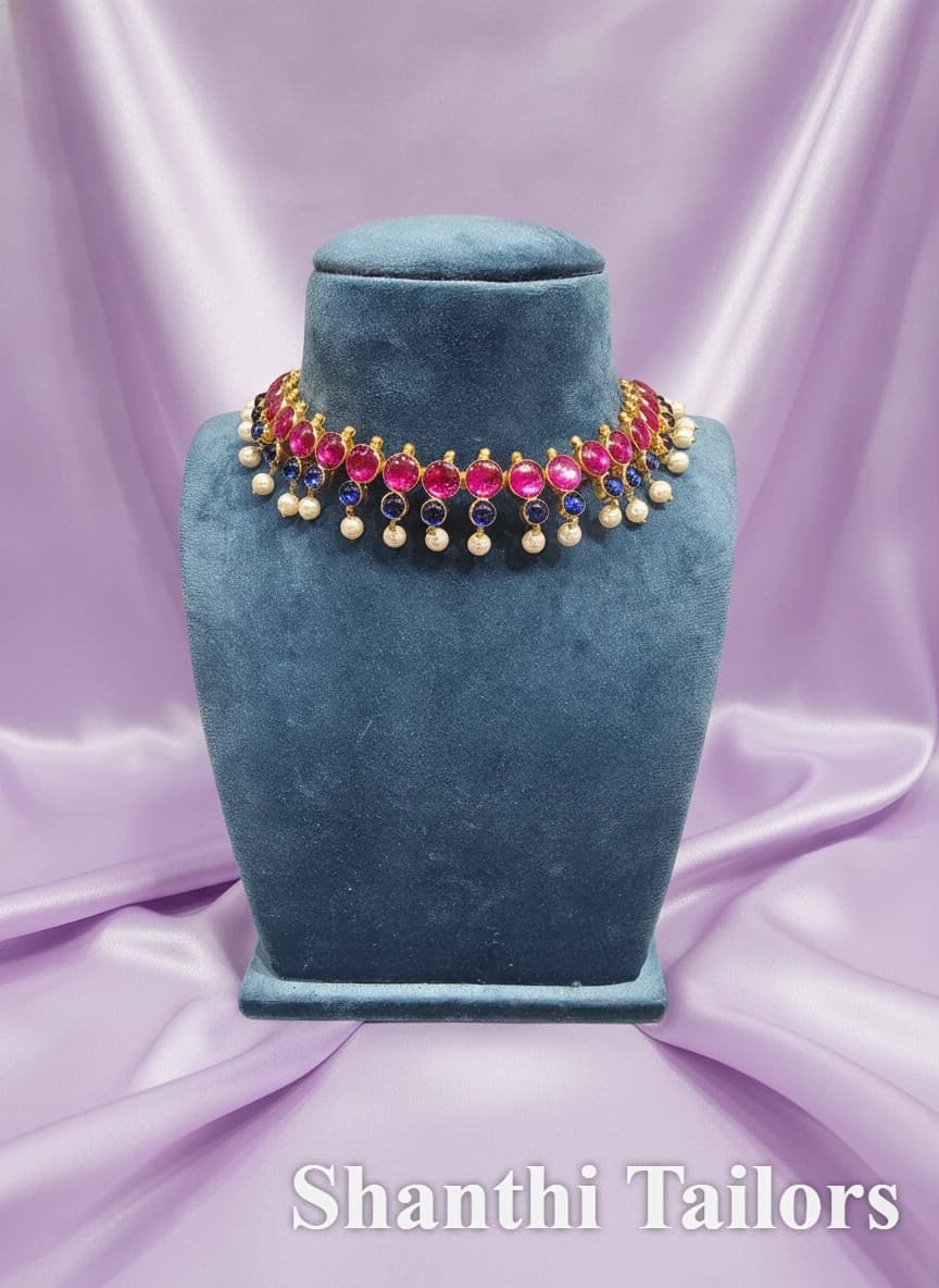 Original Temple Jewellery Kemp Stone Choker with pink & blue stones, pearl drops on a blue mannequin.
