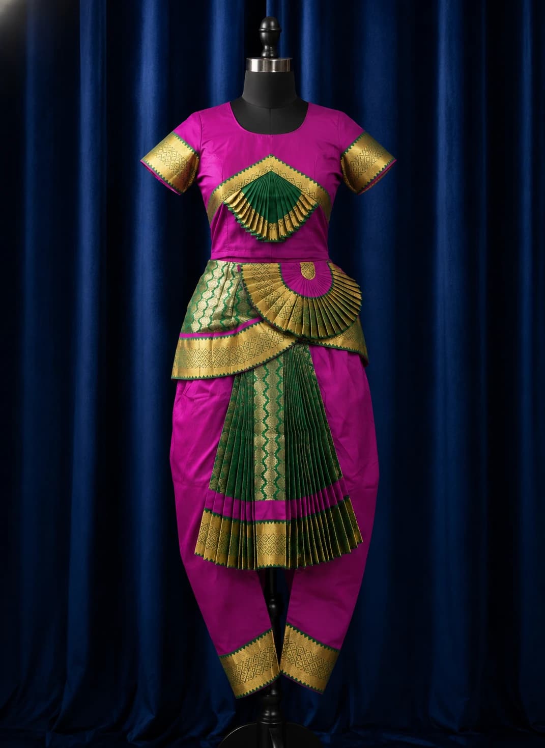 Readymade Vadamalli & green Bharathanatyam costume with gold trim & pleats on a mannequin.