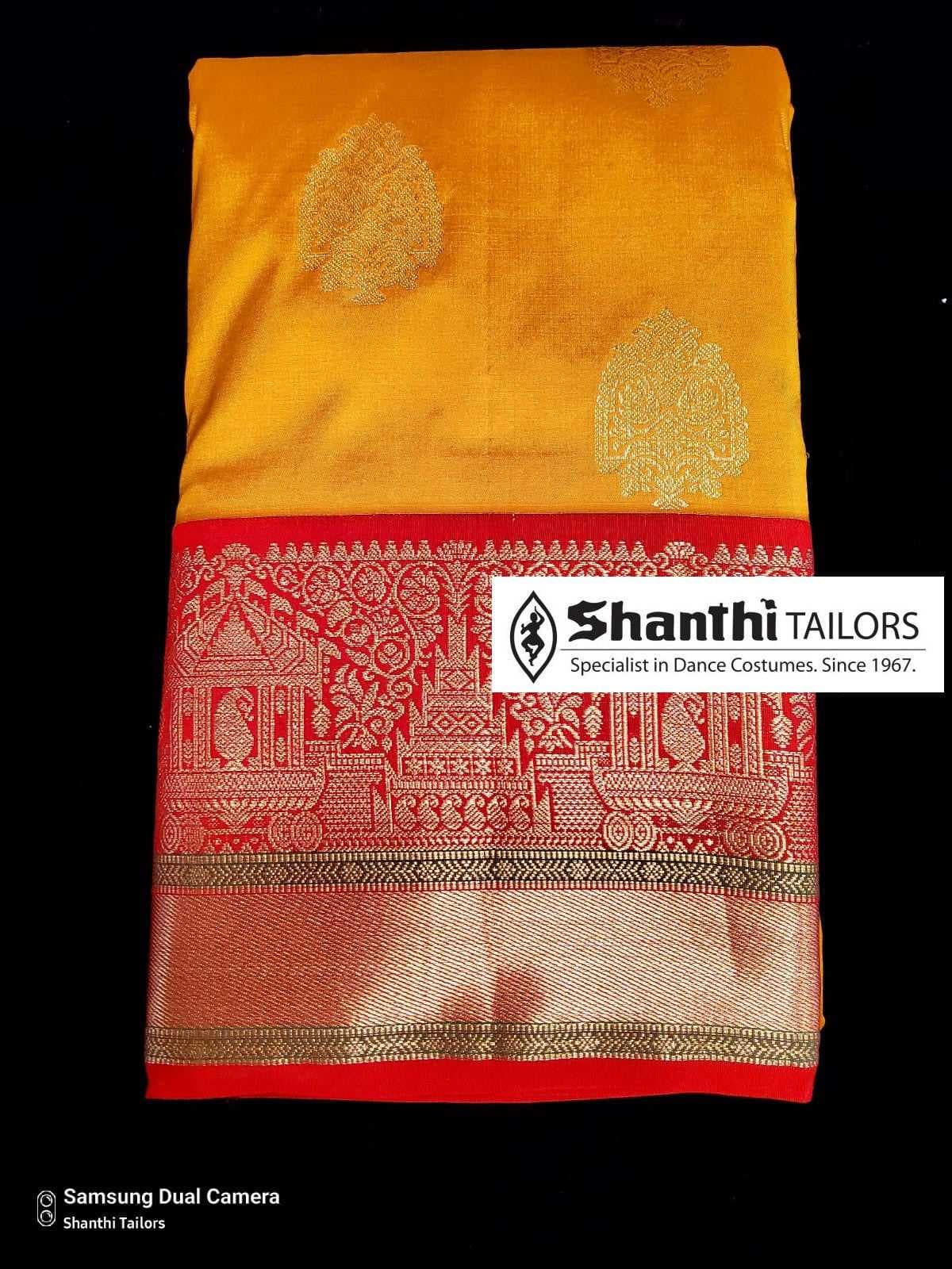 Close up of the border of the off white and gold saree, an authentic silk lookalike