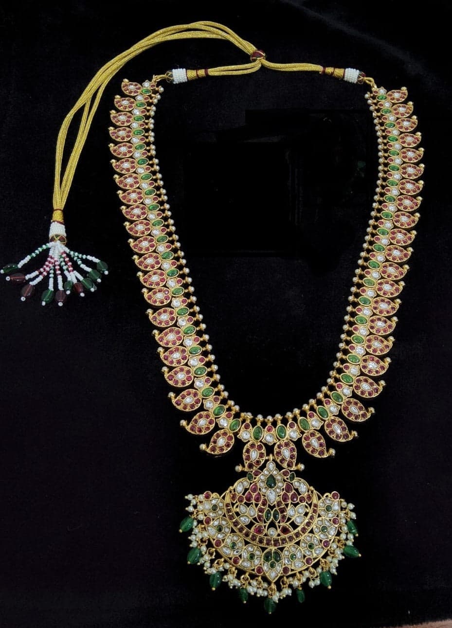 Detailed shot of Antique Mango Malai Set's copper necklace and matching jhumkis, showcasing intricate embellishments.