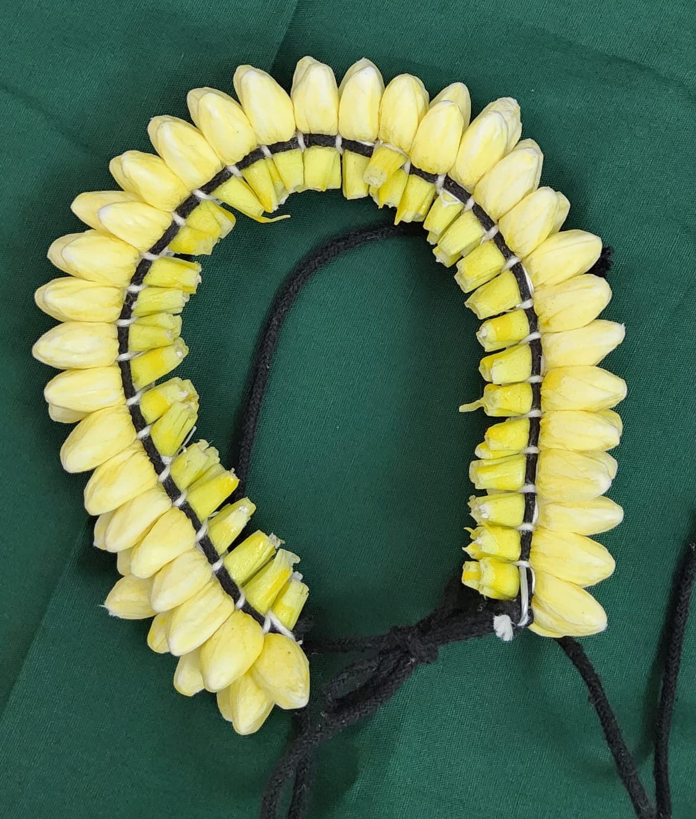 Yellow artificial jasmine flower - Shanthi Tailors paper mould hair accessory, side view.
