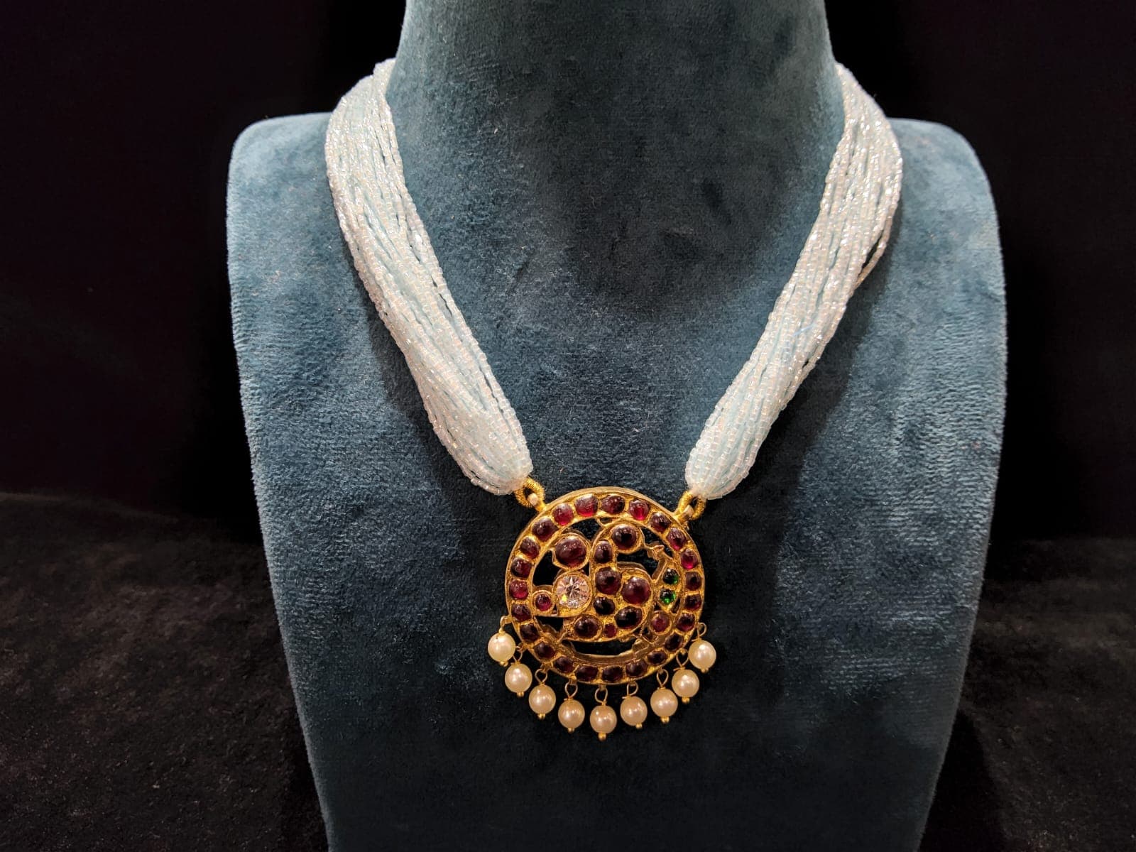 Temple jewellery beaded necklace: silver base gold leaf, side view.
