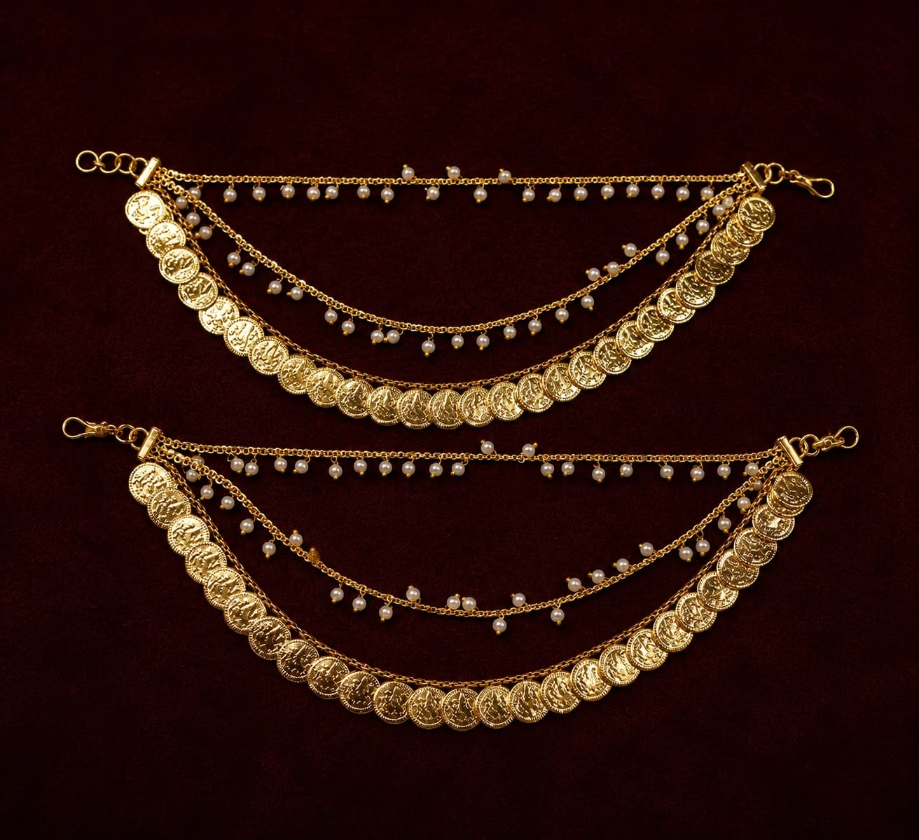 NAV663 Kasumallai Mattal fashion jewellery: two antique copper ear chains with gold coin & pearl strands on brown.