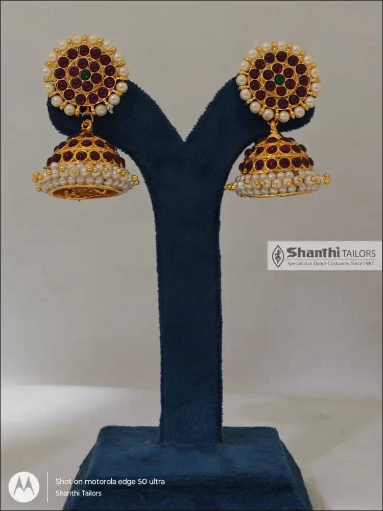 Close-up of silver base gold leaf Bharatanatyam jewellery, big jummiki earrings design.