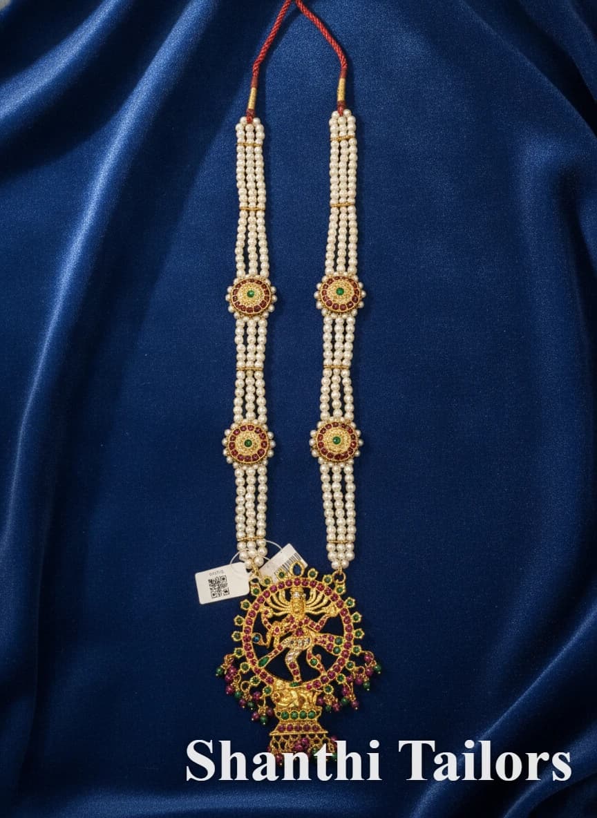 Original Stud Muthu Malai Haram (TJSTP1) temple jewelry with ornate pendant, pearls, and red & green stones.
