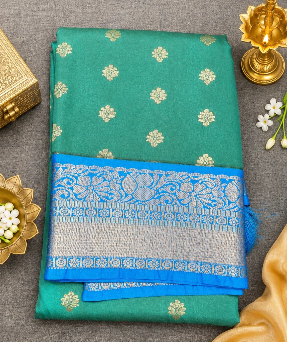 Green with Blue Margam Saree, featuring gold floral motifs & a wide silver zari woven border.
