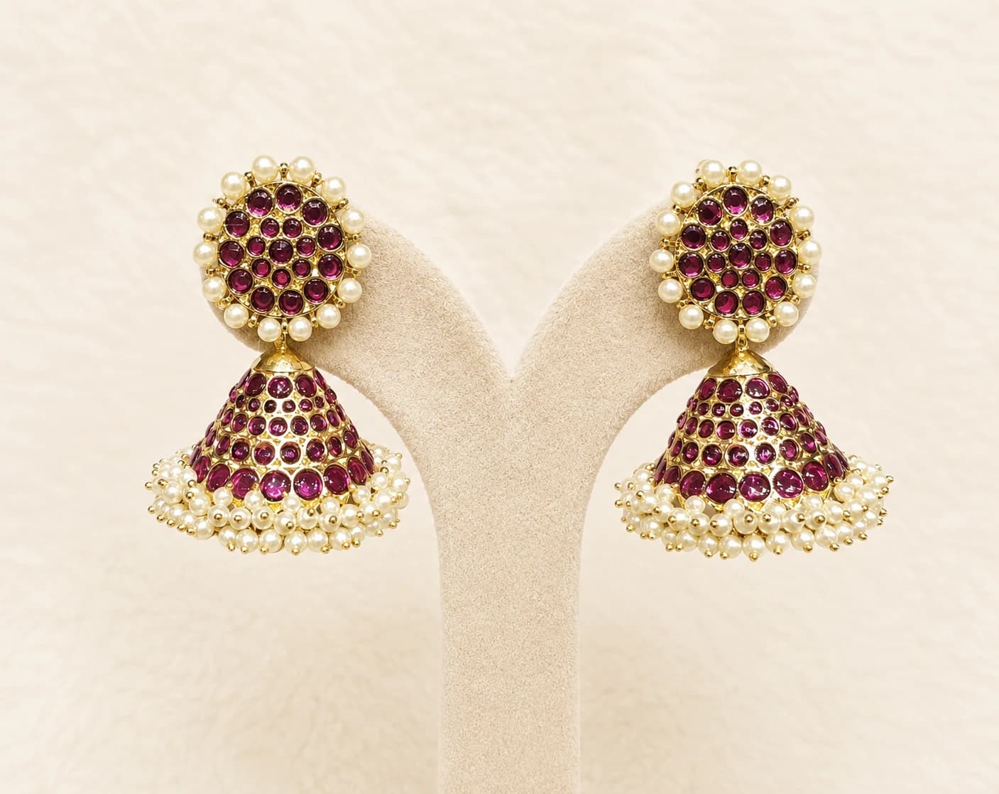 Margam Jummiki copper earrings with ruby stones and 5 lines of pearls.