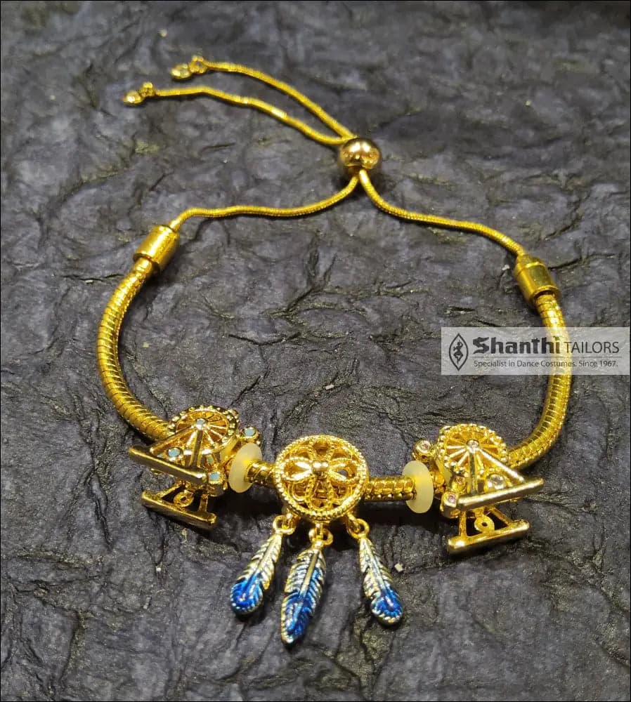 Feather Drops Bracelet: Golden bracelet with red feather charms. Perfect gift for her.