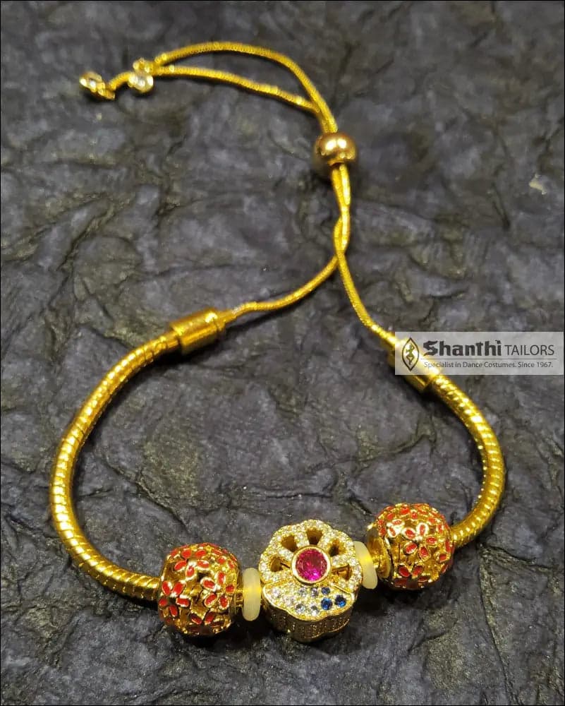 Flower Charm Bracelet: Golden floral bracelet with adjustable slider, ideal for gifting.