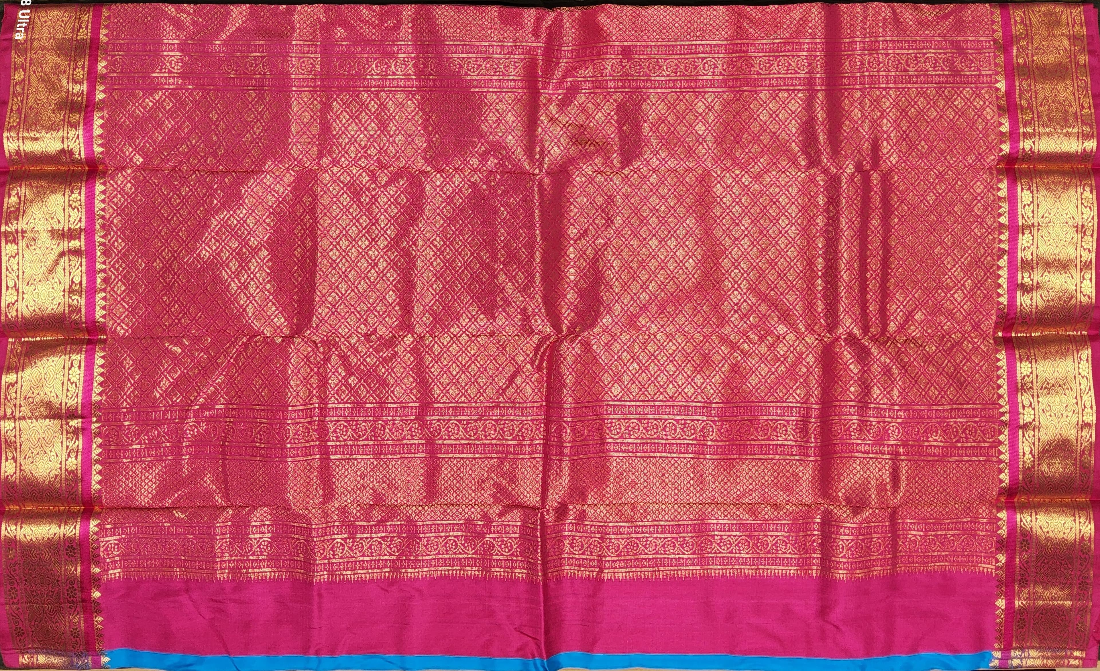 Close-up: Pink & gold zari border detail on authentic silk Dharmavaram pattu sarees.