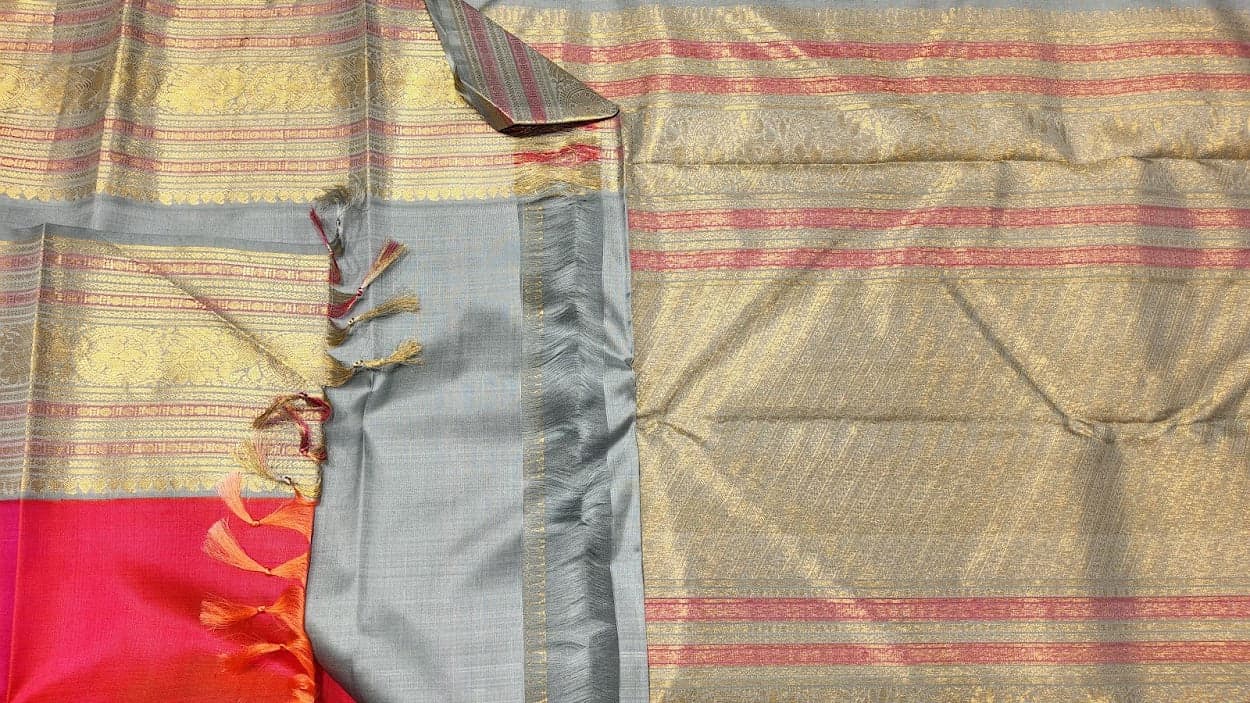 Kanchipuram authentic silk saree with hot pink blouse. Gold zari border detail, ideal for bharatanatyam.