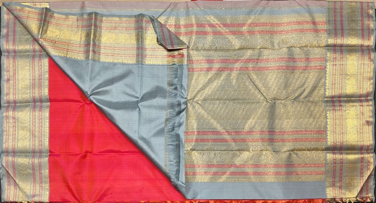 Close-up of gold zari work on Kanchipuram authentic silk saree. Temple and peacock motifs. Dharmavaram sarees.