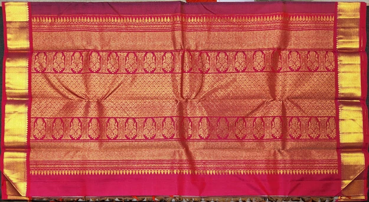 Close-up of gold zari temple motifs on grey Kanchipuram authentic silk saree.