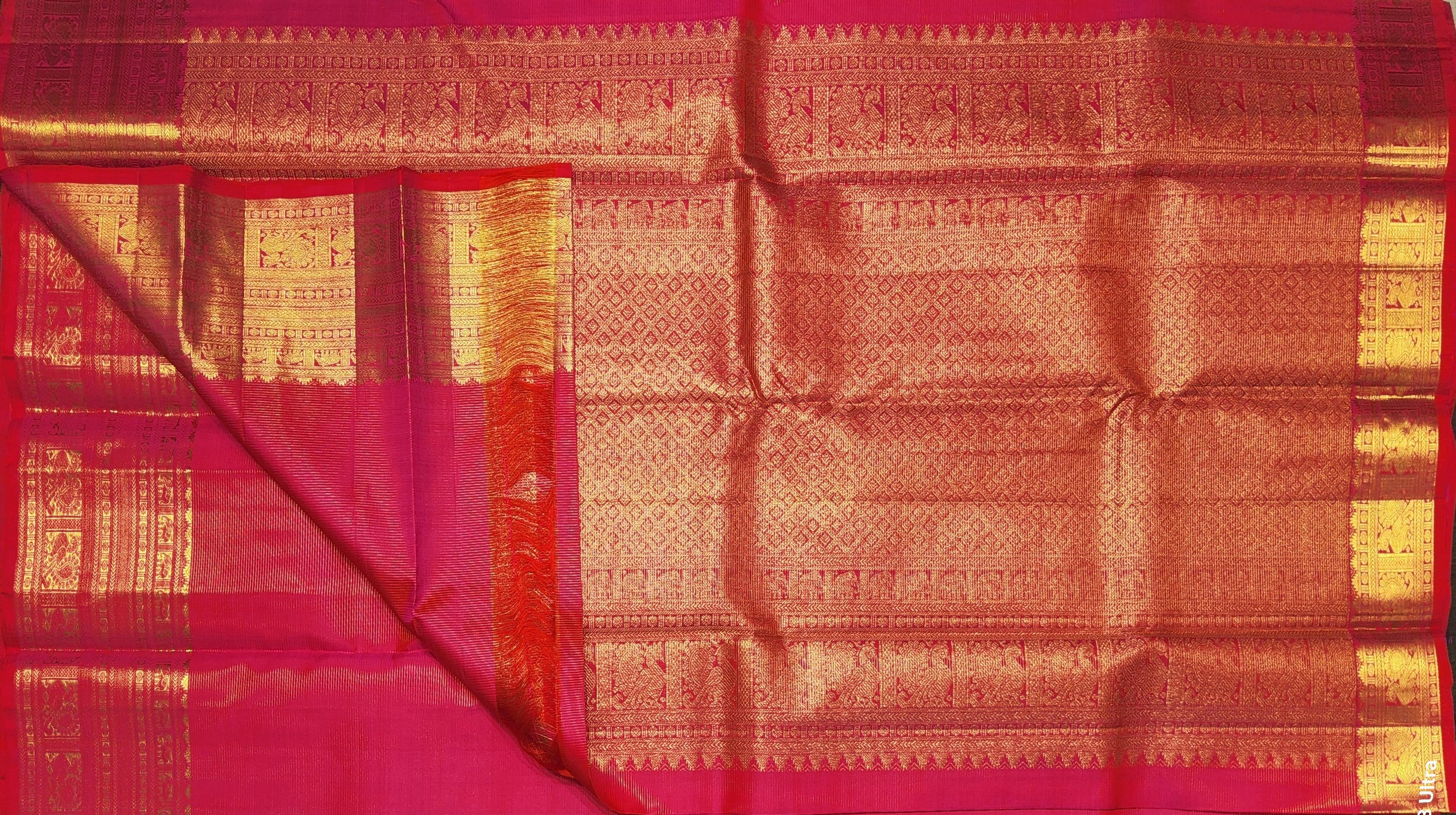 Rani pink Kanchipuram silk saree drape, gold zari border. Arangetram saree showcasing authentic silk.