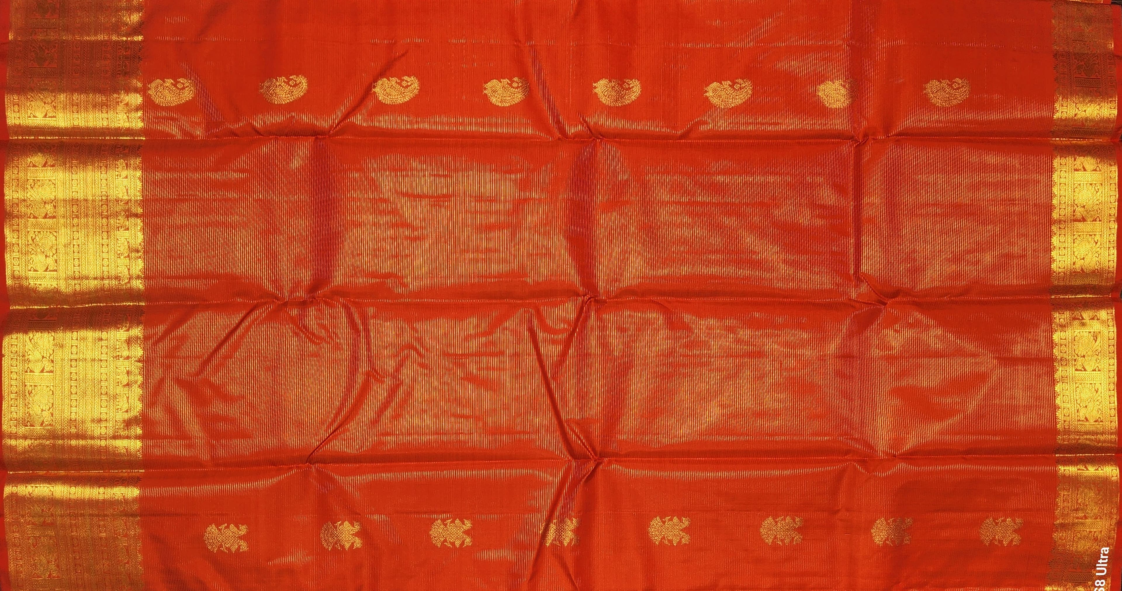 Close-up of gold zari work on authentic silk Kanchipuram saree, Arangetram saree.