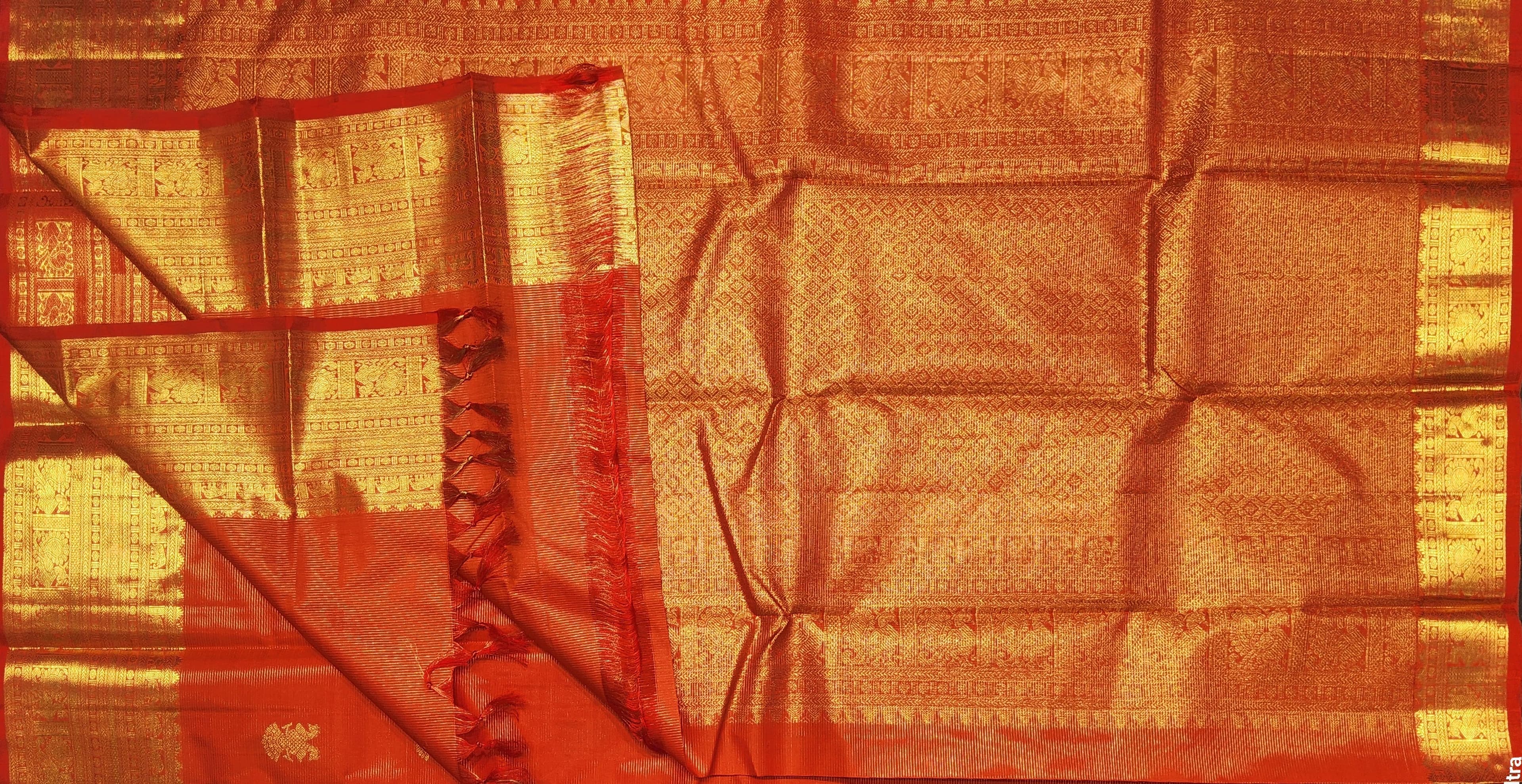 Full view of orange Kanchipuram authentic silk Arangetram saree with gold zari.