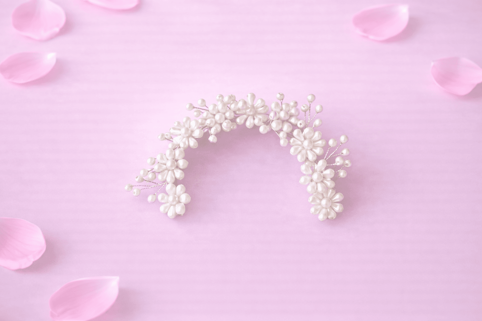 Bharatanatyam jewellery: Fuchsia rose pearl veni on dark background. Wedding hair accessory.