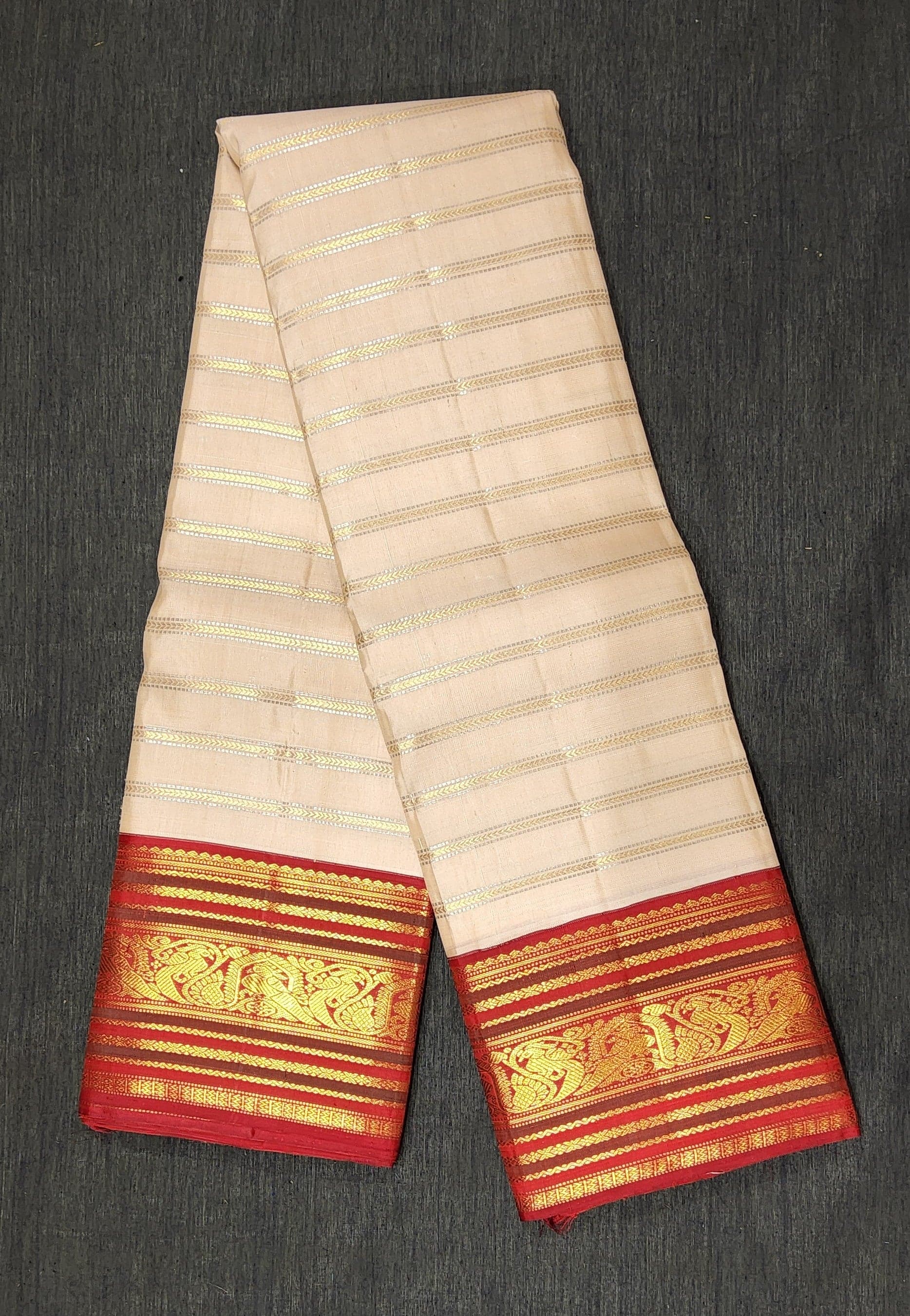 Off White Kanchipuram authentic silk saree for Arangetram; gold zari stripes and maroon border.