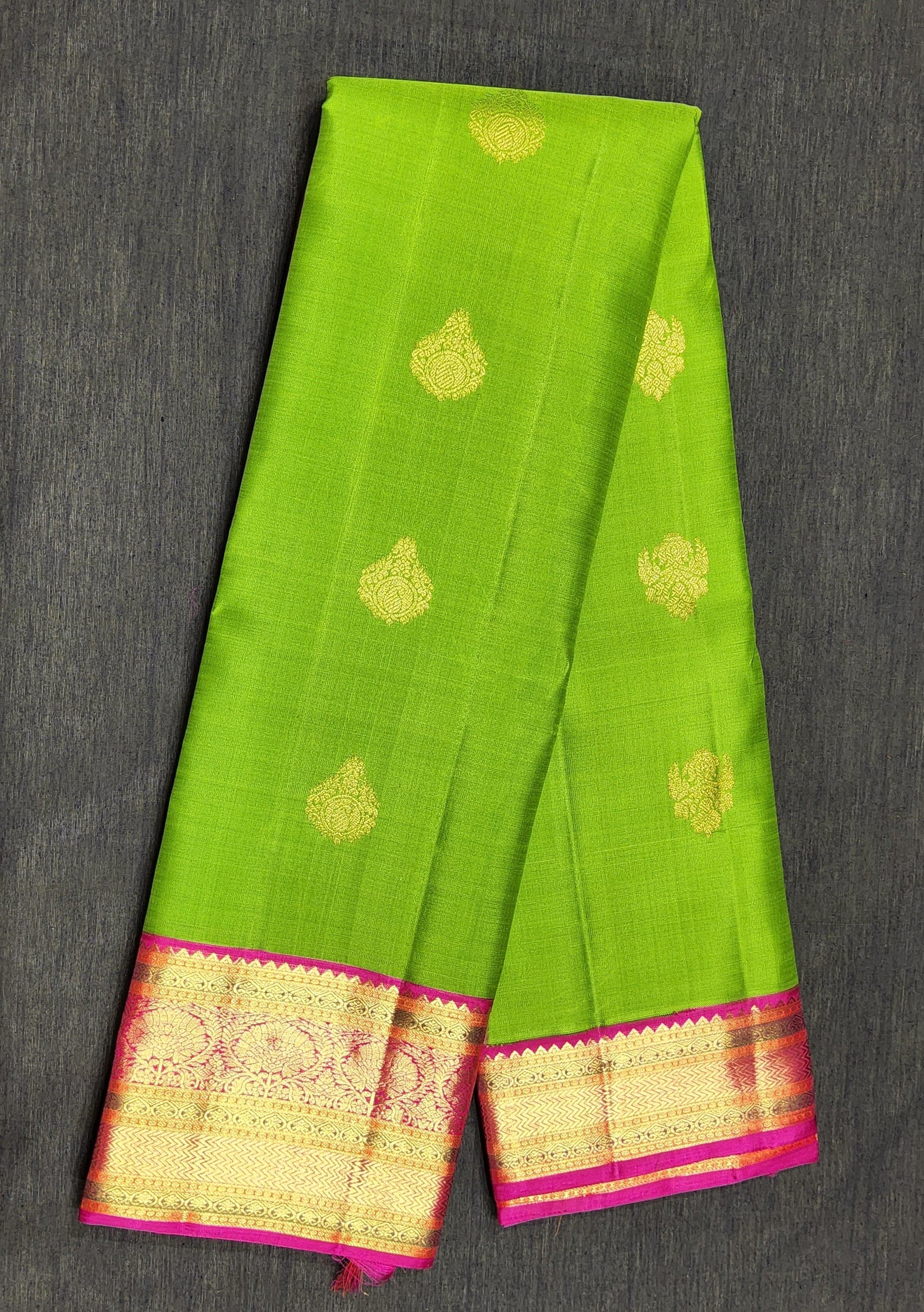 Close-up of rani pink border with gold zari on a Green Kanchipuram silk saree. Dharmavaram pattu sarees influence.