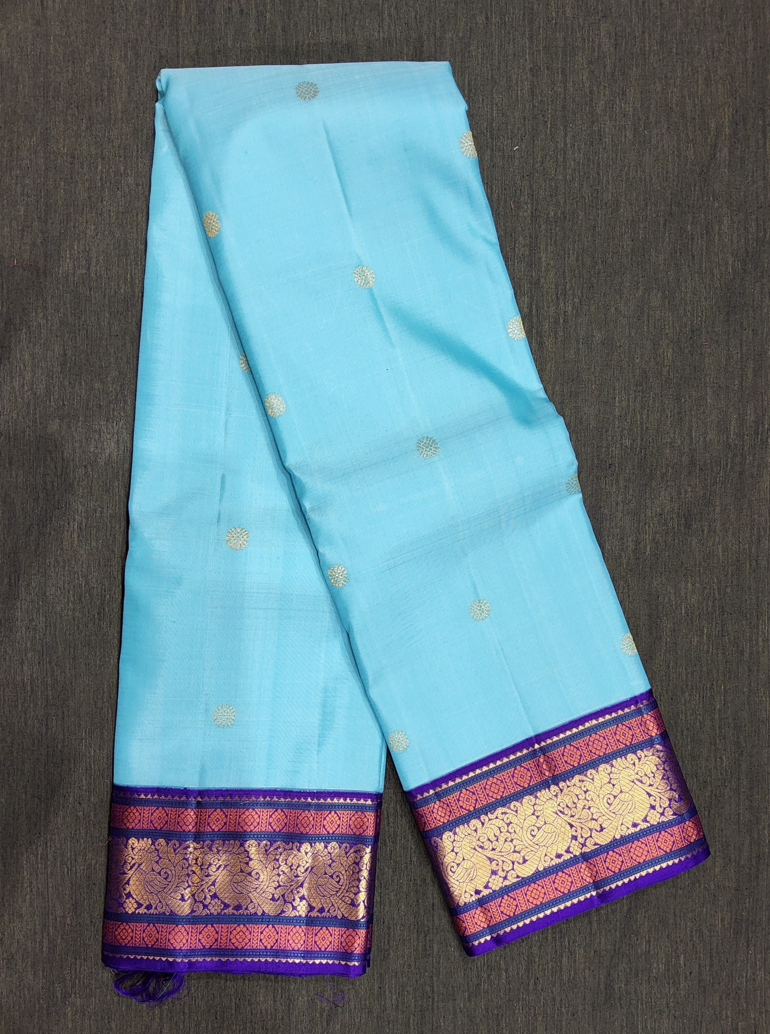 Close-up of gold zari parrot motifs on purple Kanchipuram authentic silk saree, suitable for Bharatanatyam.