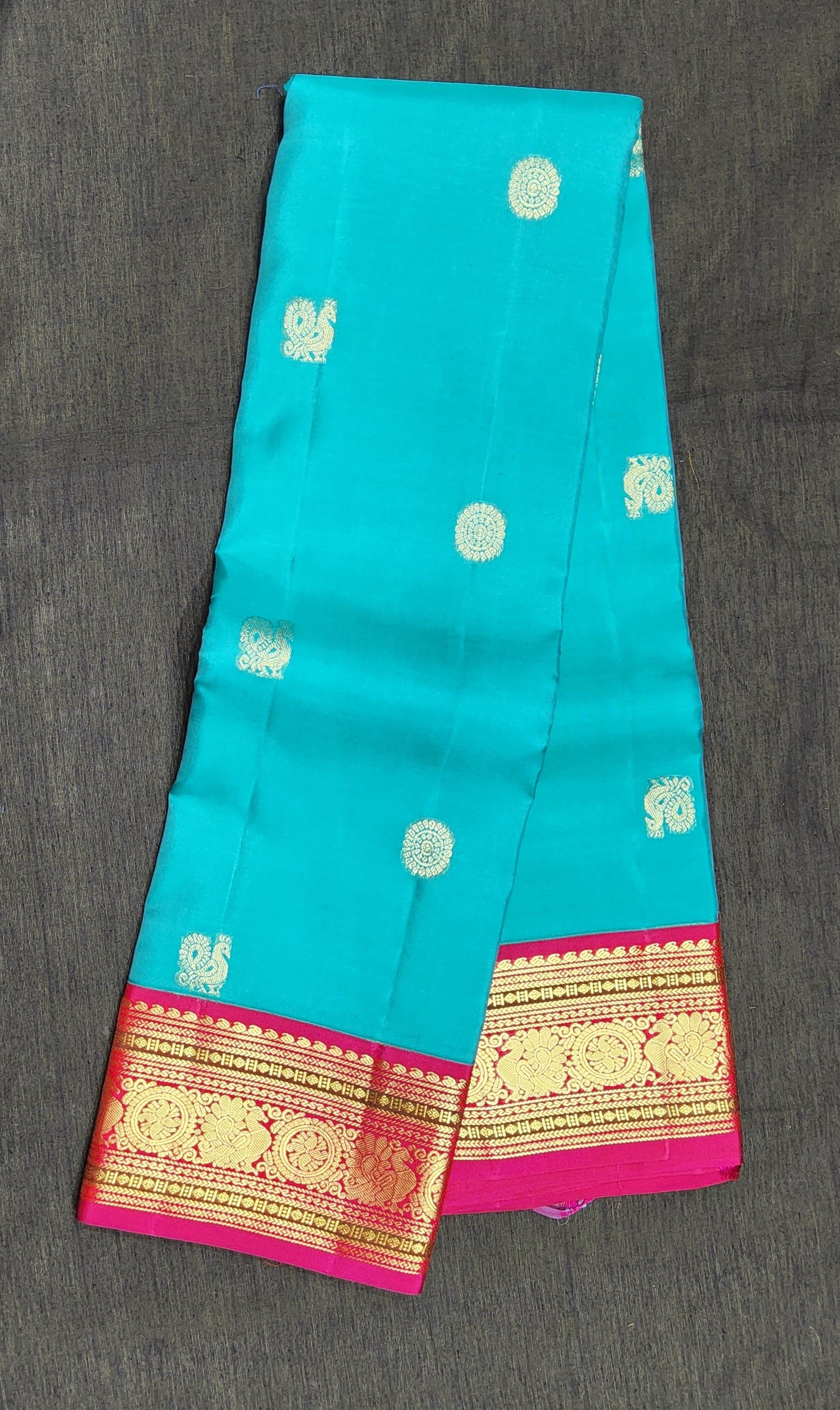 Close-up of gold zari peacock motifs on authentic silk Kanchipuram saree, perfect for arangetram.